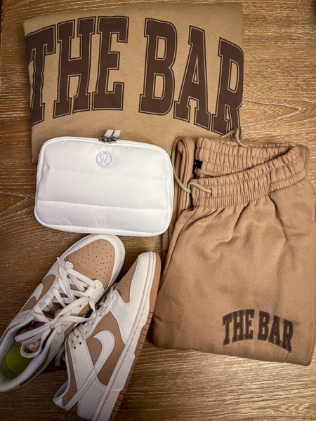 THE BAR Restock happening today!!! 11 CT | noon ET. The day everyone was waiting for is here haha ! My travel outfit in one pic. The Bar Varsity Sweatshirt on Chocolate Chip I’m always getting XL for oversized fit . Bridget The Bar. Nike Dunk Low. Lululemon Athletica Everywhere Belt Bag. 

#LTKFindsUnder100 #LTKStyleTip #LTKTravel