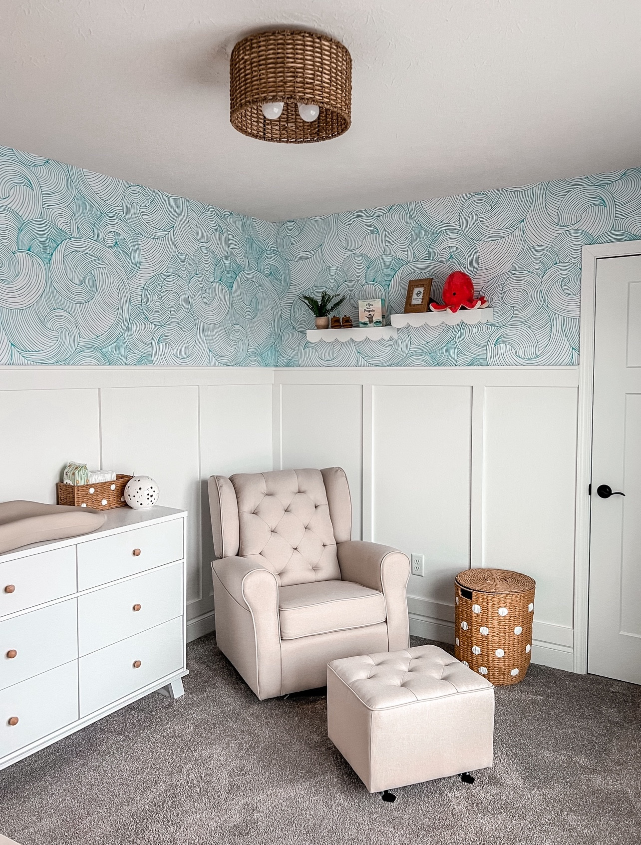 Luca’s Nursery! When finding out we were having a boy last year I was in straight panic mode. For five years all I knew was pink, bows and all things princess. Designing a space around a boy theme was super hard for me. I don’t naturally gravitate towards hunter green, dark blue or moody colors so I knew I needed light and airy. After months I settled on a little ocean theme vibe that started with that sweet orangey red octopus up on the wall. Using that as my inspiration I went straight to work and gathered a mood board of all things ocean, waves and texture! This is the final product! What don’t think? 

Wallpaper- Loomwell
Scallop Shelves- Hobby Lobbyy