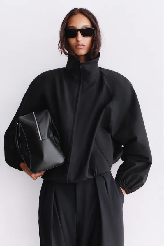 High-neck, long-sleeve jacket with shoulder pads. Features front zip pockets. Hem finished with a... | Zara US