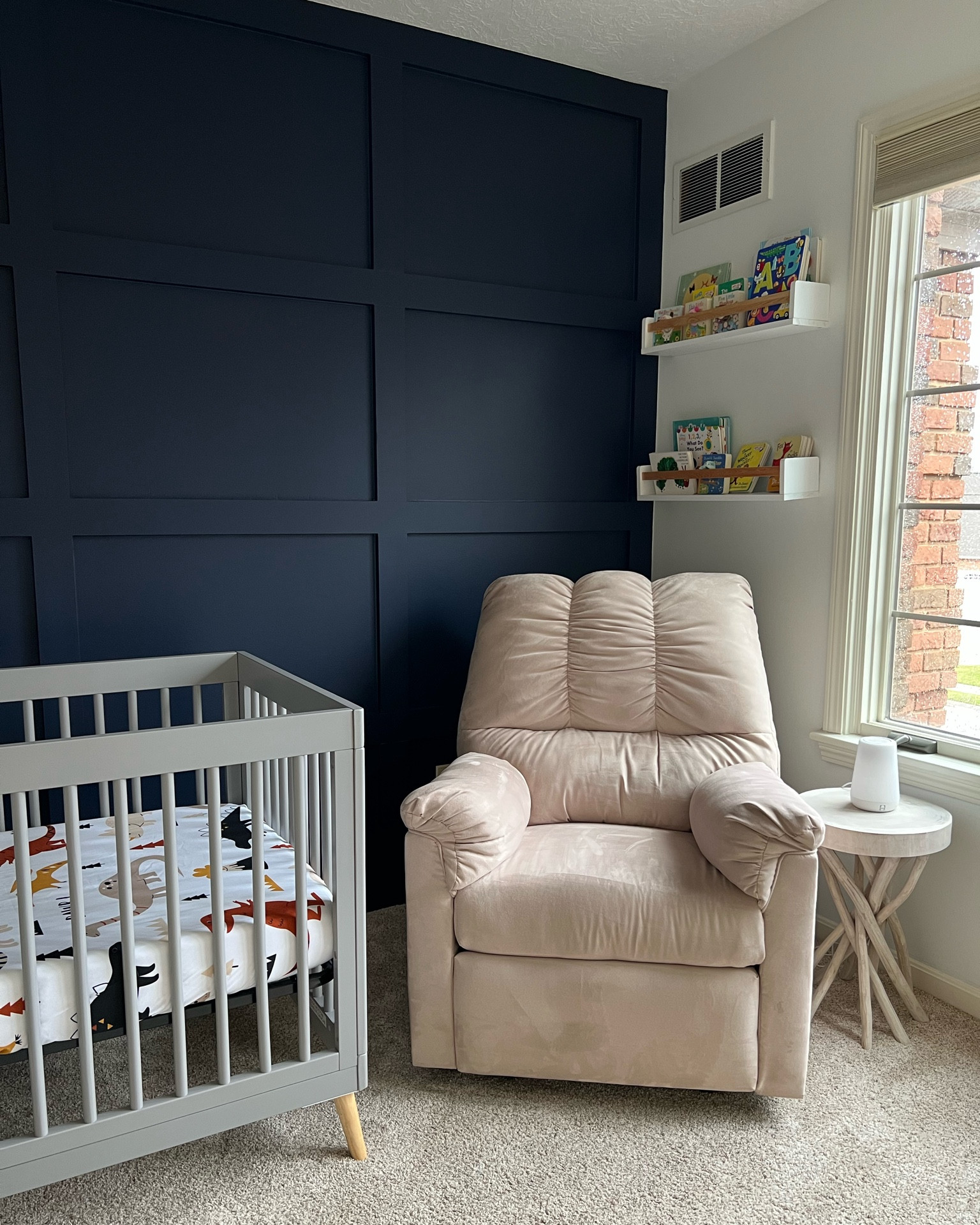 Baby boy nursery. Nursery decor. Boho Dino nursery. Dinosaur theme nursery decor. Nursery shelves. Nursery inspo. Simple nursery design. Crib. Board and batten wall. Nursery accent wall. Navy blue wall. Nursery chair. Recliner. 

#LTKhome #LTKbaby