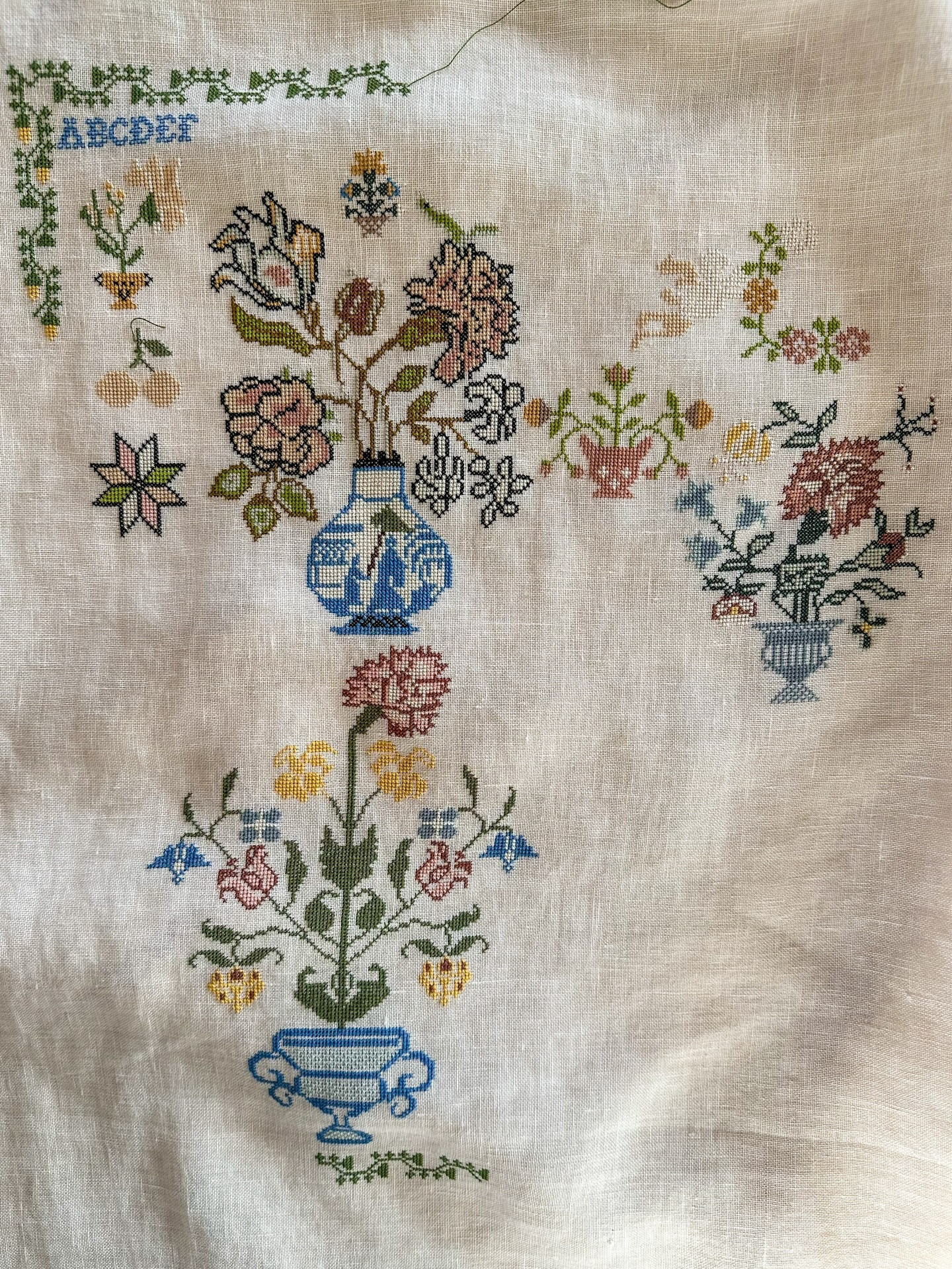 When you finish a flower motif in cross stitch, there’s that tiny, quiet pause—needle hovering, thread resting—where you get to admire what didn’t exist a moment ago. A few careful stitches, a bloom coaxed into being, petal by petal. It feels like a small victory, a soft reminder that patience makes beautiful things, even one square at a time 🌸🧵
.
.
Pattern: Ida Dorothea Lamberts 1806 @riesgigi 
Floss- DMC stitching one over two 
Linen- Weeks Dye Works 36 count beige 
.
.
.
.
#samplerstitching #crossstitchaddict #onestitchatatime #flowermotif #simpleisbeautiful