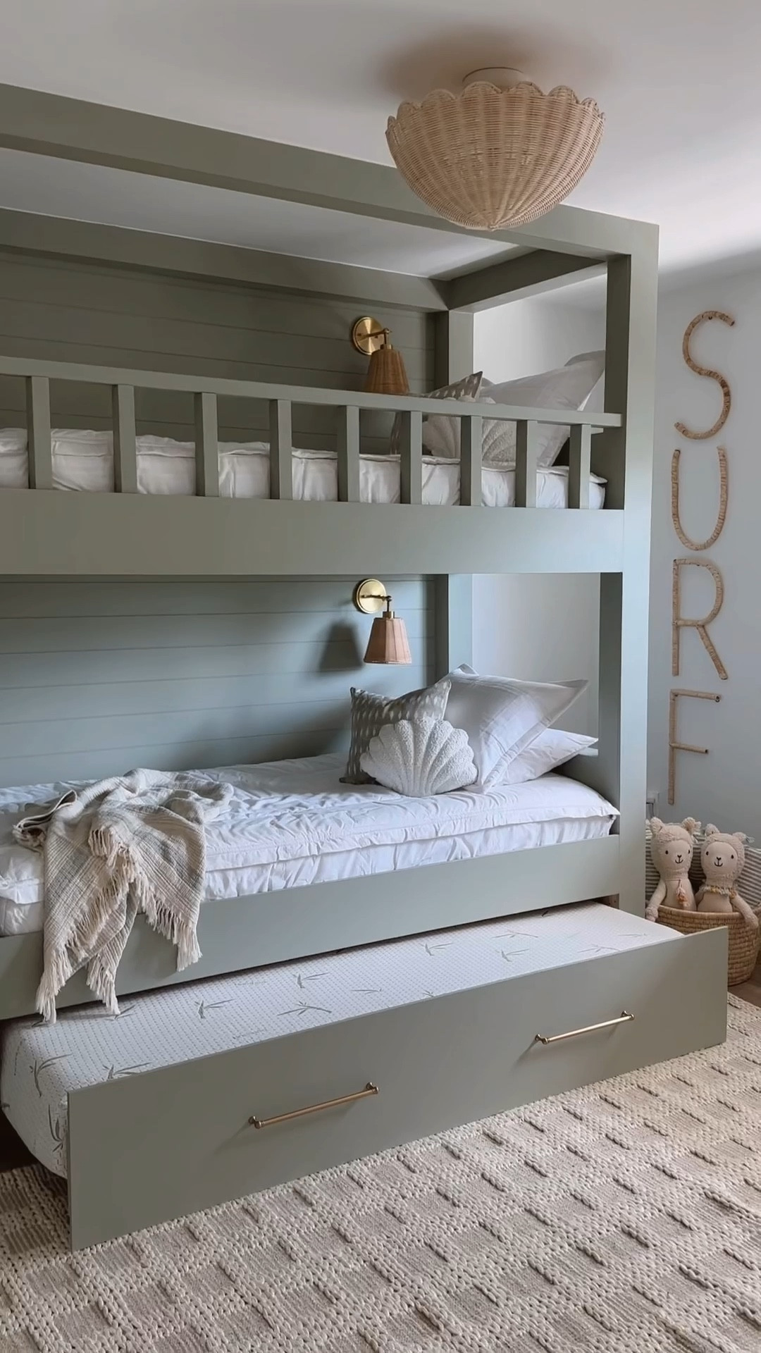 Beach house bunk room for the kids 🤍🐚

#bunkroom #kidsroom #beachhouse #kidsdecor #bunkbeds #shell #rug #sconce #rattanlight #wovenlight 

#LTKVideo #LTKHome #LTKFamily