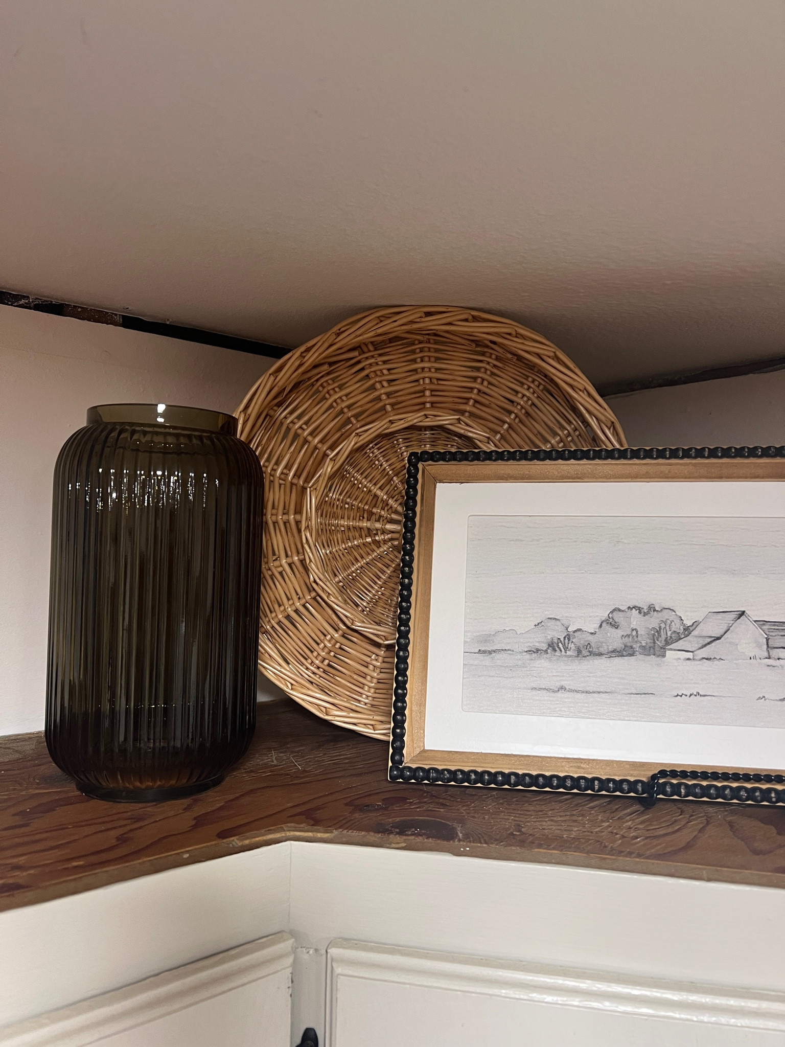 Over the cabinet decor for fall :) the picture is last year hobby lobby and the wicker is thrifted!

#LTKSeasonal #LTKHoliday #LTKhome