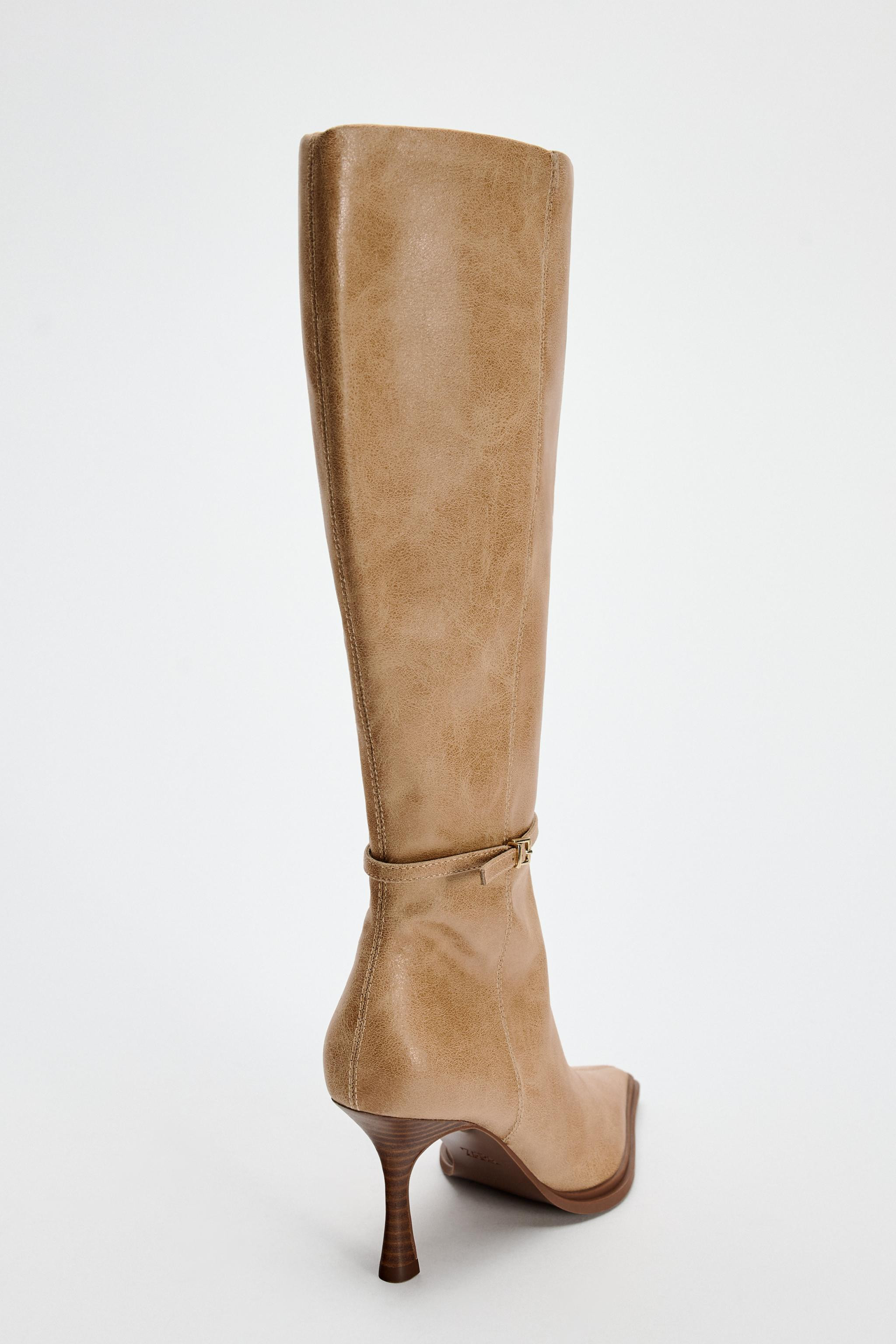Knee high boots. Thin heel. Strap with buckle detail at around the ankle. Zip closure. Pointed to... | Zara US