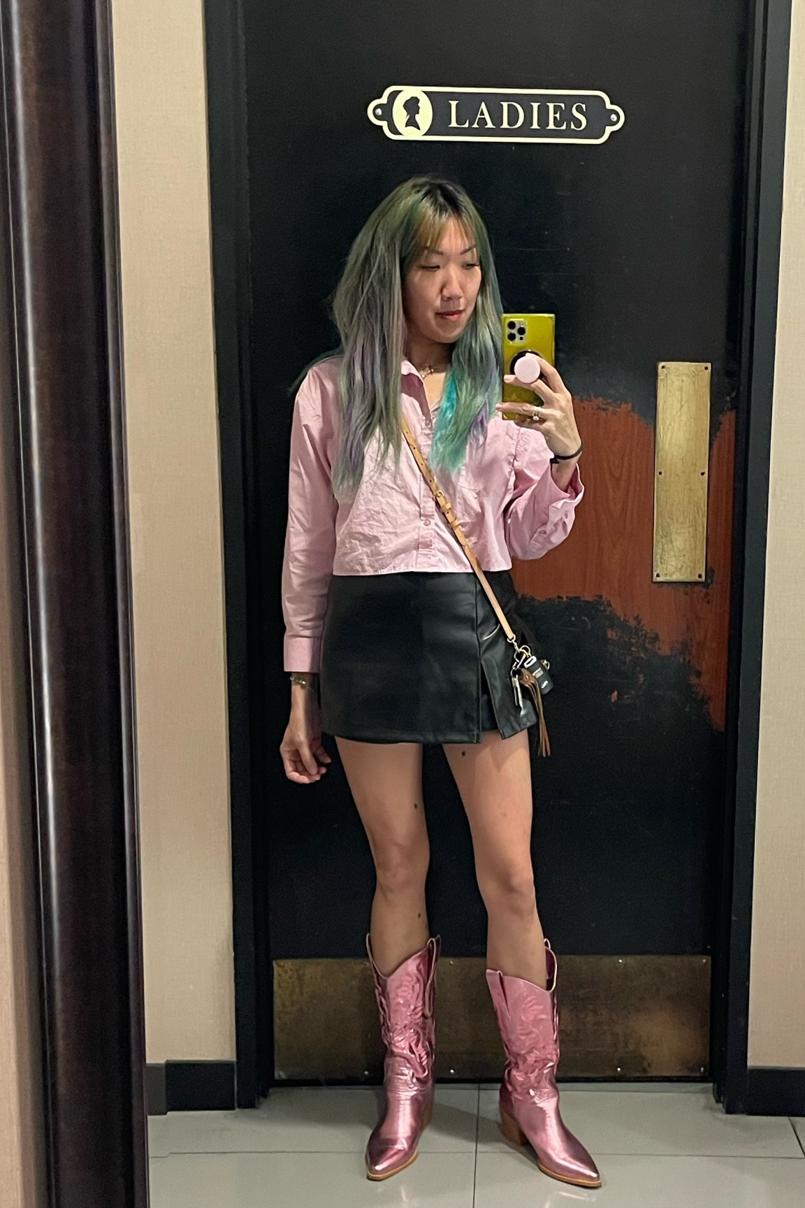 OOTD light pink cropped button up shirt- perfect for an alternative Easter look, PU leather pleather black skort mini skirt, and metallic pink knee high cowboy cowgirl  boots. 