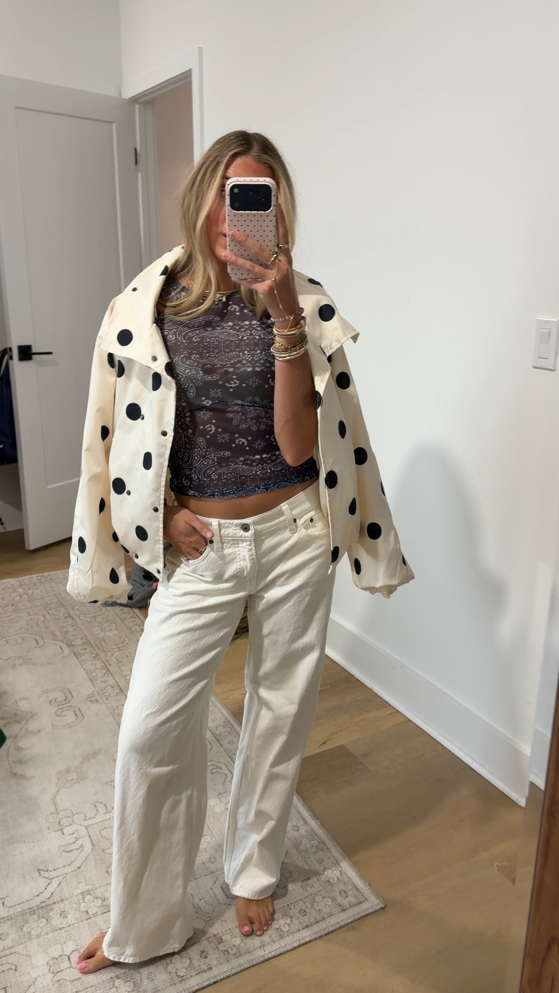 rainy and gross so gotta bring some fun with the outfit I’m wearing my @abercrombie low rise loose white jeans paired with my new @renttherunway miaou mesh short sleeve tee (code RTRXSVOSEN50) with the skims wireless bra and my polka dot amazon windbreaker jacket