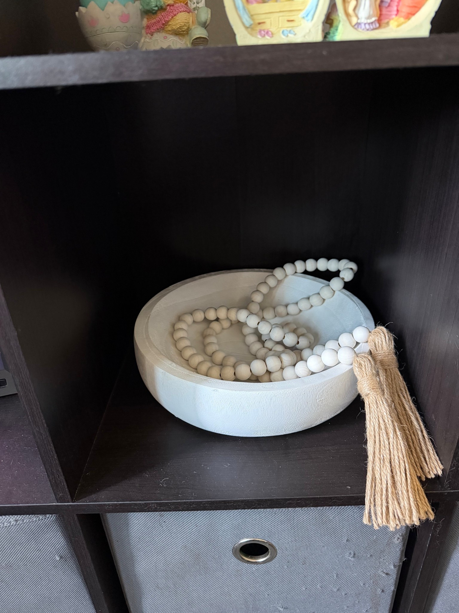 Added this decorative bowl and bead garland to my 9 cube storage under my tv

#LTKHome
