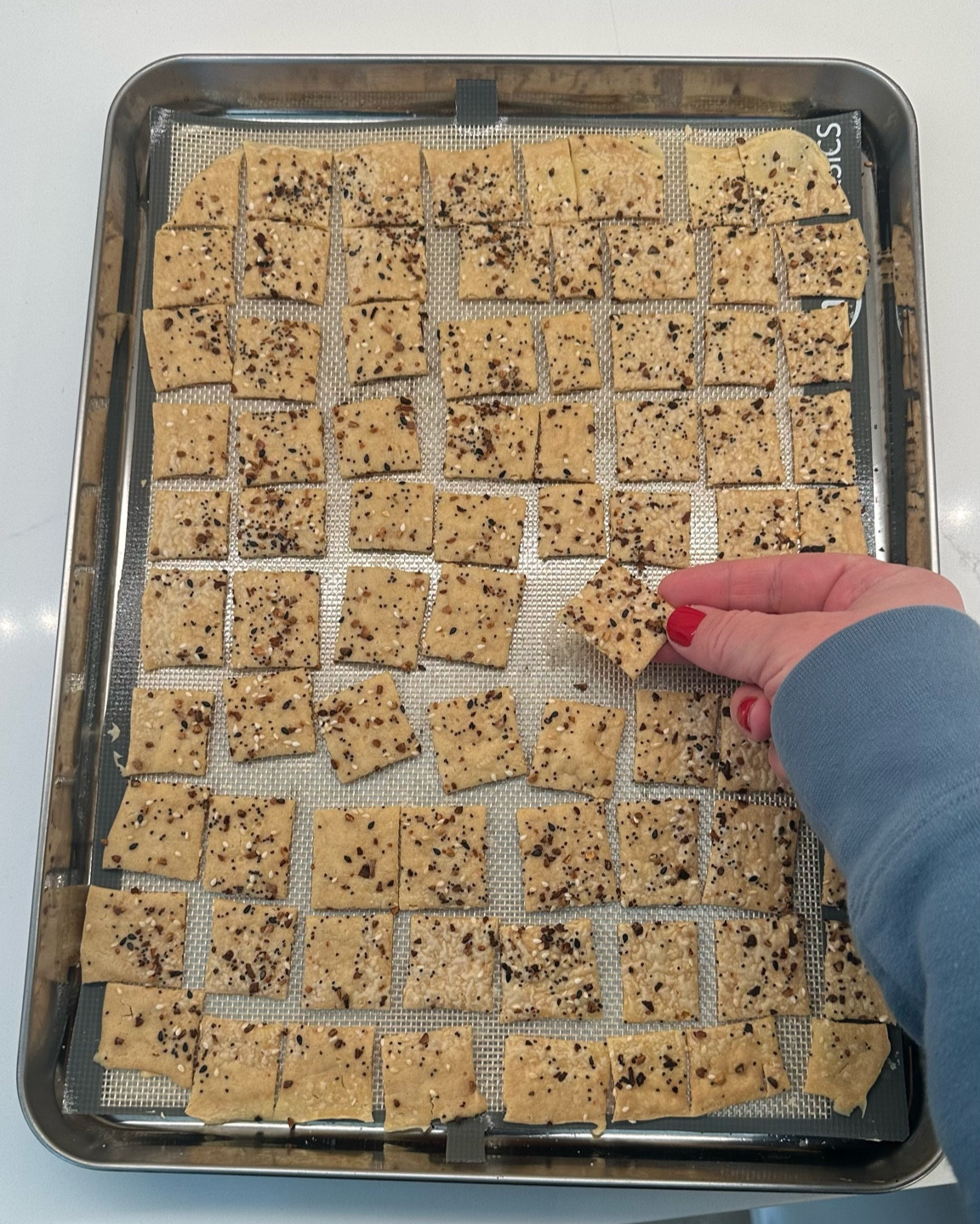 The rimmed baking sheet and silicone baking mat I use for sourdough crackers