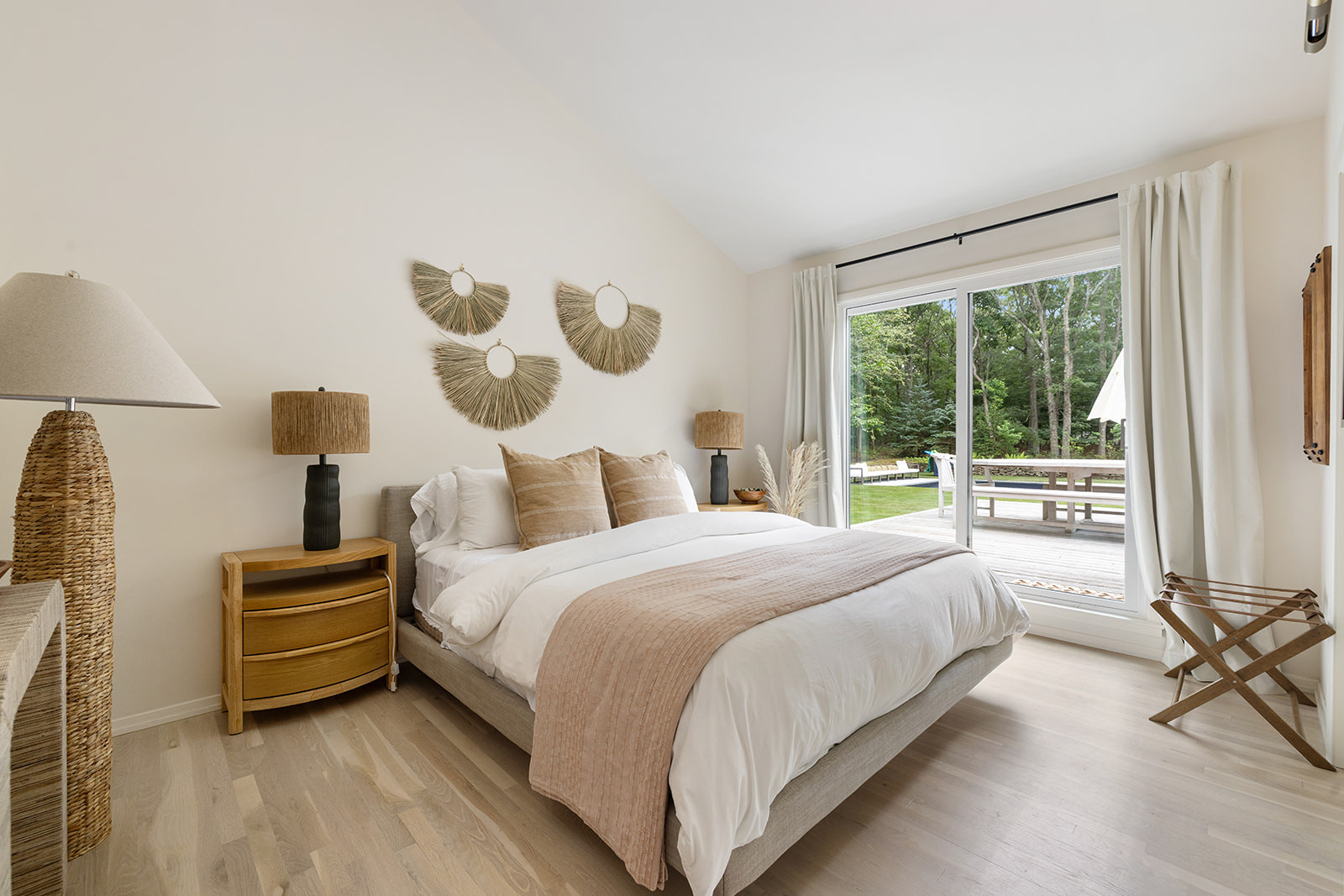 Guest bedroom with crisp white bedding, layered neutral textures, simple furnishings, and direct access to the outdoor dining deck. The goal was to keep the room comfortable, fresh, and inviting for guests without adding too much. Linking the exact and similar pieces here.

#LTKActive #LTKHome #LTKSaleAlert