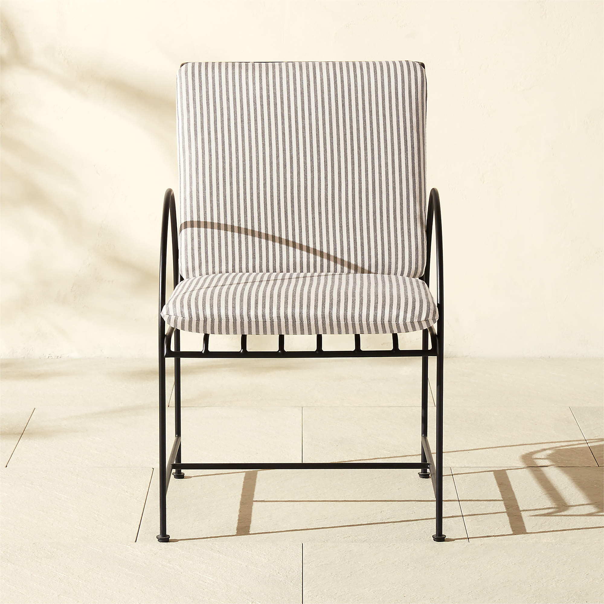 Costa Black Metal Outdoor Dining Armchair with Black and White Striped Sunbrella Cushion | CB2 | CB2