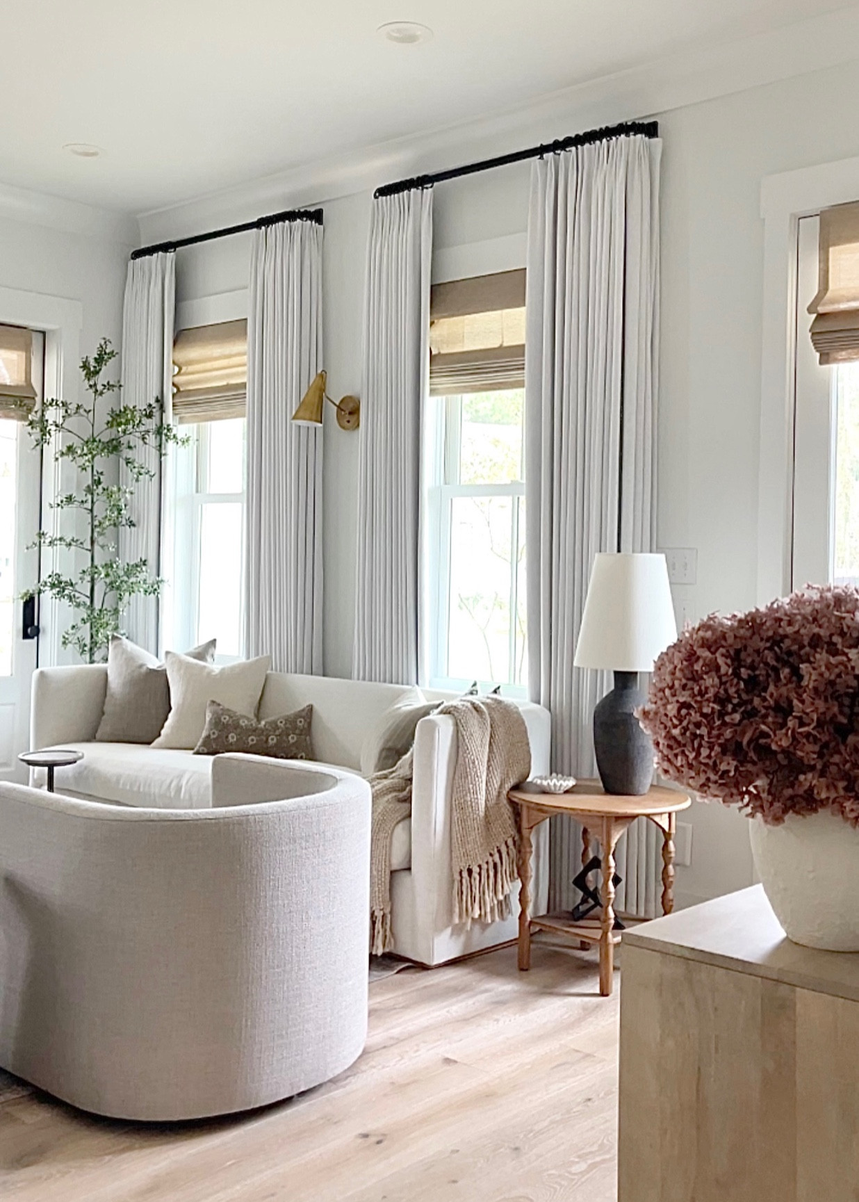 Living room decor, white linen two Pages curtains, gray modern barrel chairs, wooden side table, best faux olive tree, throw blanket, home decor, window shades, black lamp, mcgeeandco, Lulu and Georgia 

#LTKsalealert #LTKSeasonal #LTKhome