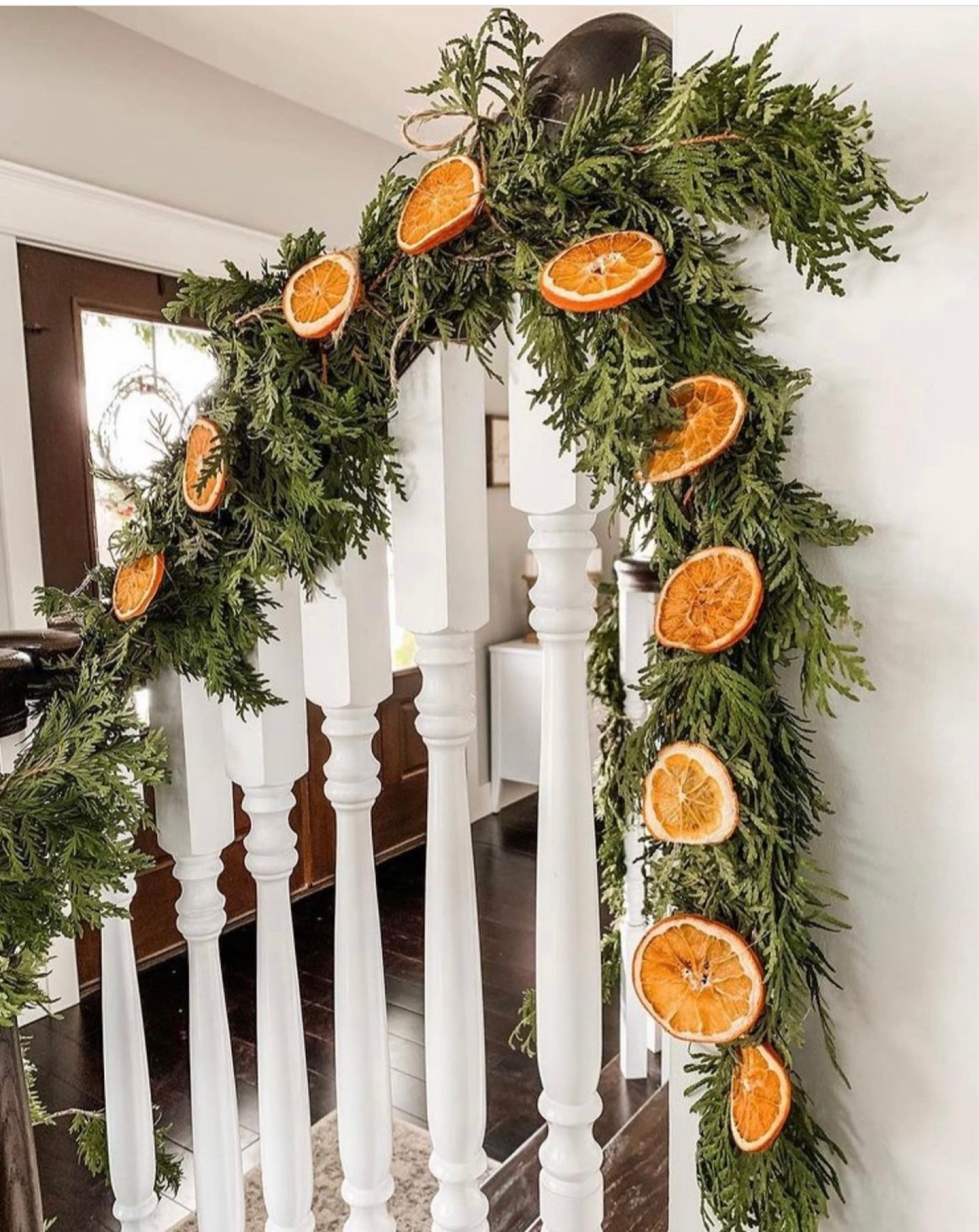 Christmas garland. Dried orange slices added. Scandinavian Christmas decor. Living room. Staircase decorations. Holiday display. 

#LTKhome #LTKSeasonal #LTKHoliday