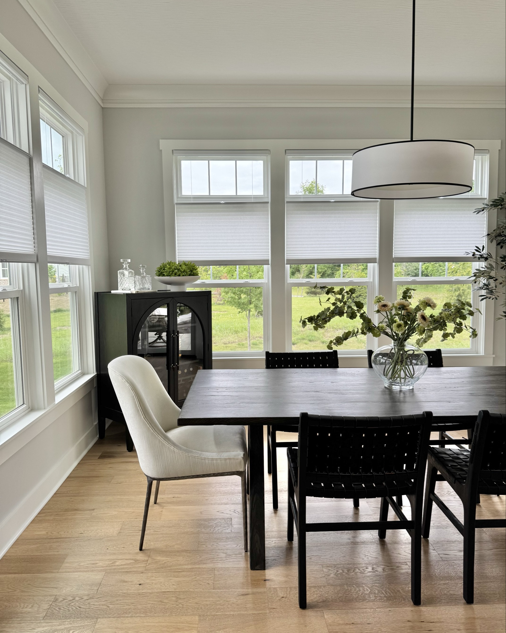 This gorgeous eat in kitchen space is simple yet so elevated! We opted for captain’s chairs at each end for the adults, while keeping things a bit safer for the kids with an easy to clean chair option. Then, we added a beautiful centerpiece as well as a bar cabinet and greenery to finish the space. I love how this room turned out! Note that many of these pieces are are only available through trade, so I linked many similar options to get the same look!

#LTKHome #LTKFamily #LTKStyleTip
