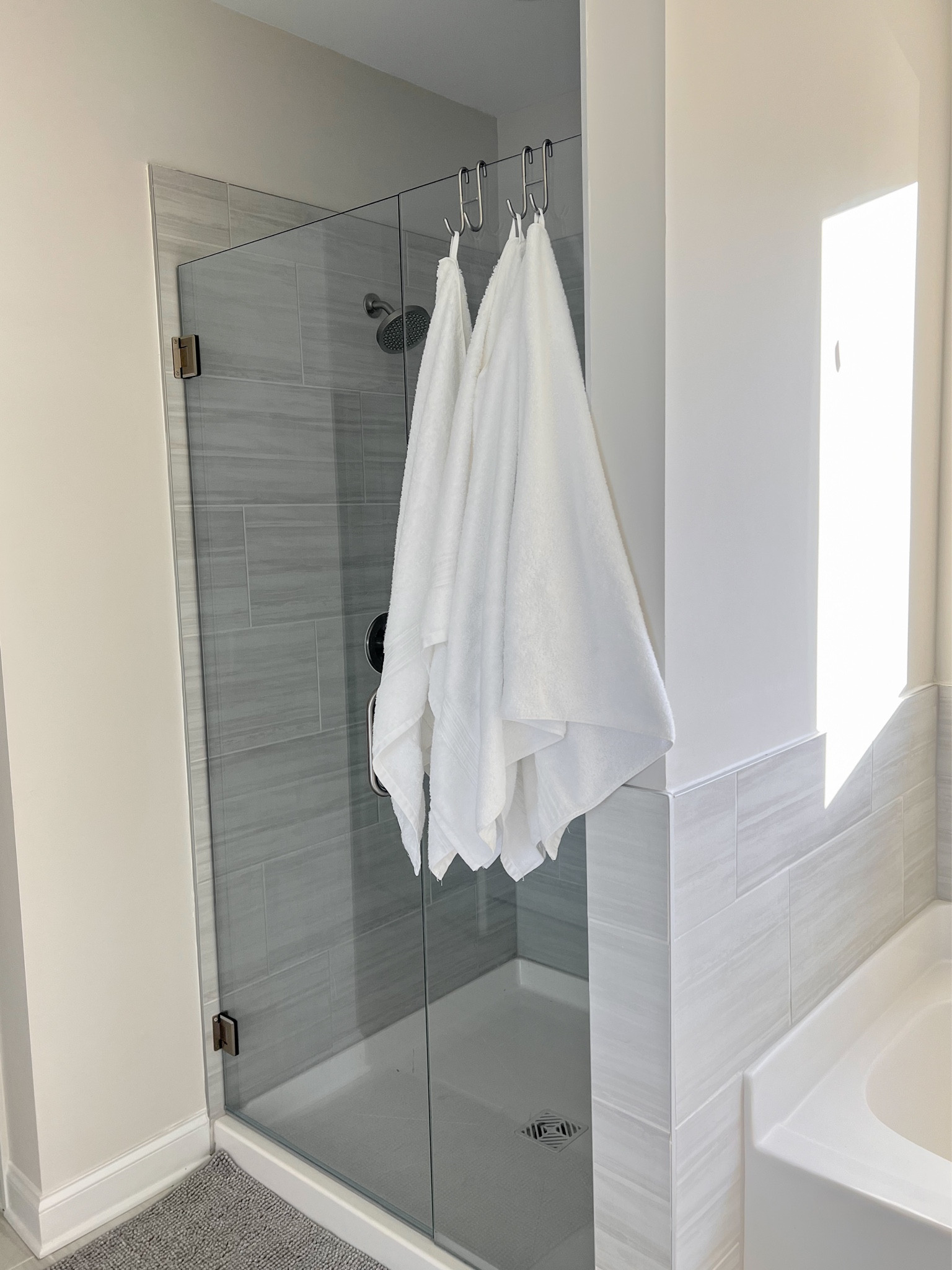 These shower hooks have been an absolute game changer for our bathroom. We don’t have an area close to the shower and don’t want to put any holes in the walls, so these check all the boxes! 🙌🏻 #shower #towels #bathtowel #minimalbathroom 

#LTKHome #LTKKids #LTKFamily
