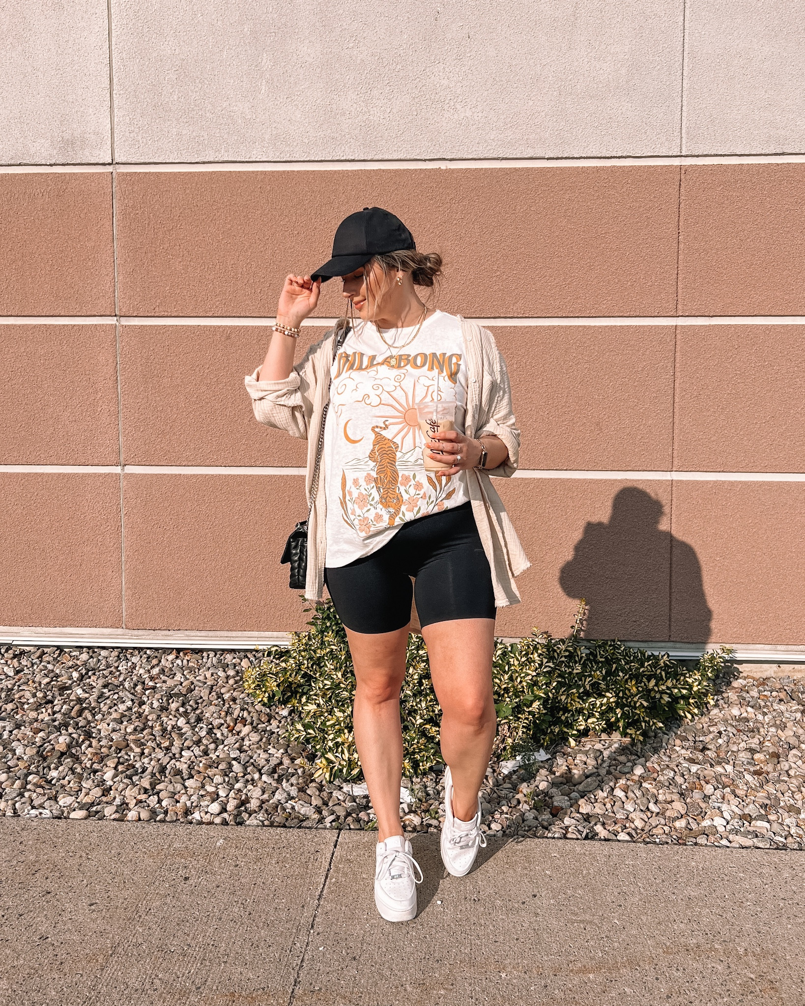 Casual comfy summer outfit - oversized graphic tee (linked similar), my fave button up shirt, seamless black biker shorts, baseball cap, white sneakers 

Midsize fashion, summer ootd


#LTKFind #LTKstyletip #LTKSeasonal