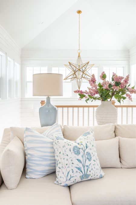 Our loft living room decorated for spring! I used these pink lilac stems, ribbed white vase, colorful oushak rug, linen sectional, light wood console table, blue lamps, striped ottoman cube, brushstroke throw pillow and floral pillow for pops of spring. See our full spring home tour here: https://lifeonvirginiastreet.com/2024-spring-home-tour/
.
#ltkhome #ltksalealert #ltkfindsunder50 #ltkfindsunder100 #ltkstyletip #ltkseasonal spring living room, sectional styling, colorful spring decor

#LTKhome #LTKsalealert #LTKSeasonal