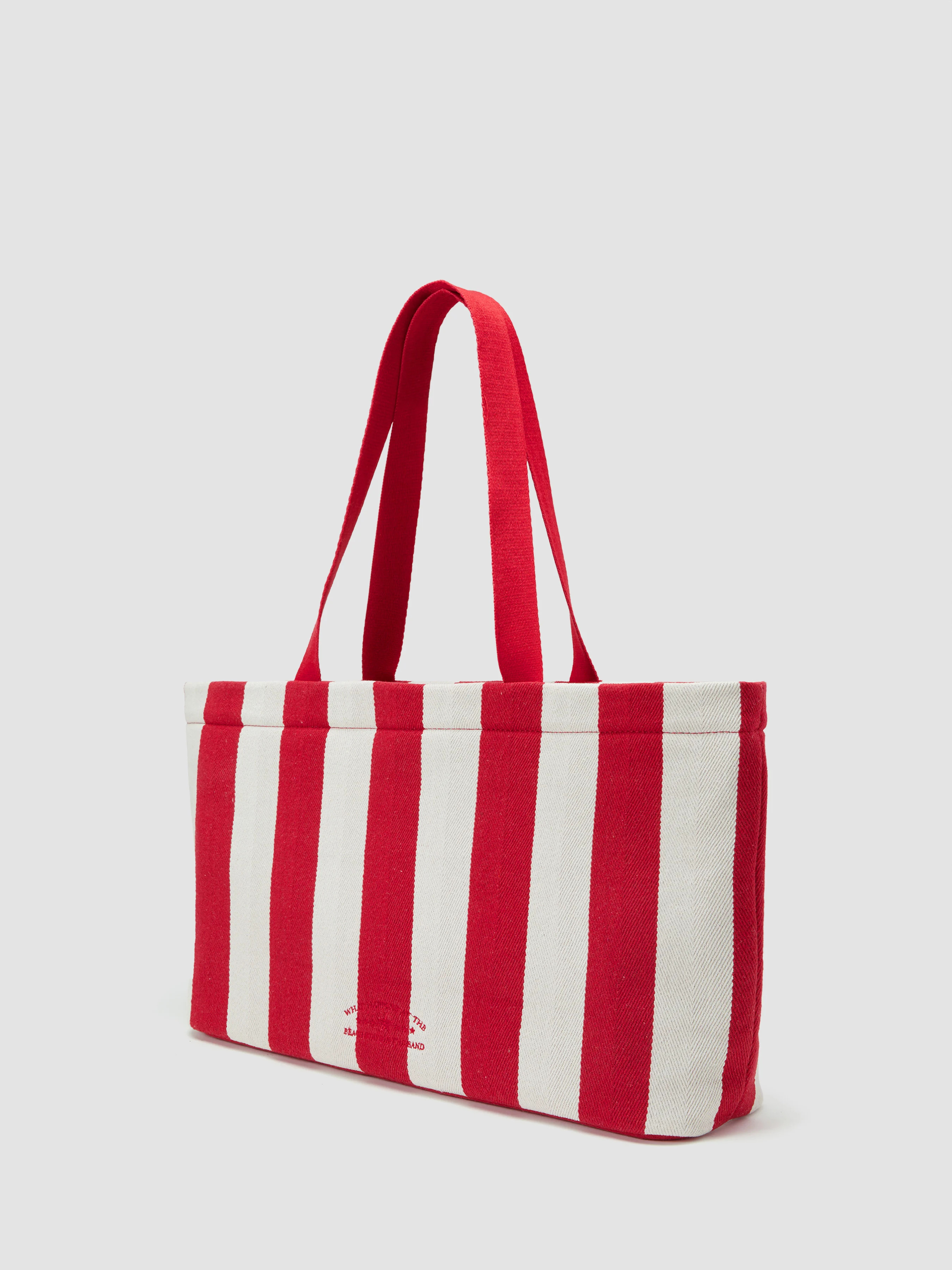 WHAT HAPPENS AT THE BEACH STAYS IN THE SAND STRIPED TOTE BAG | Cider