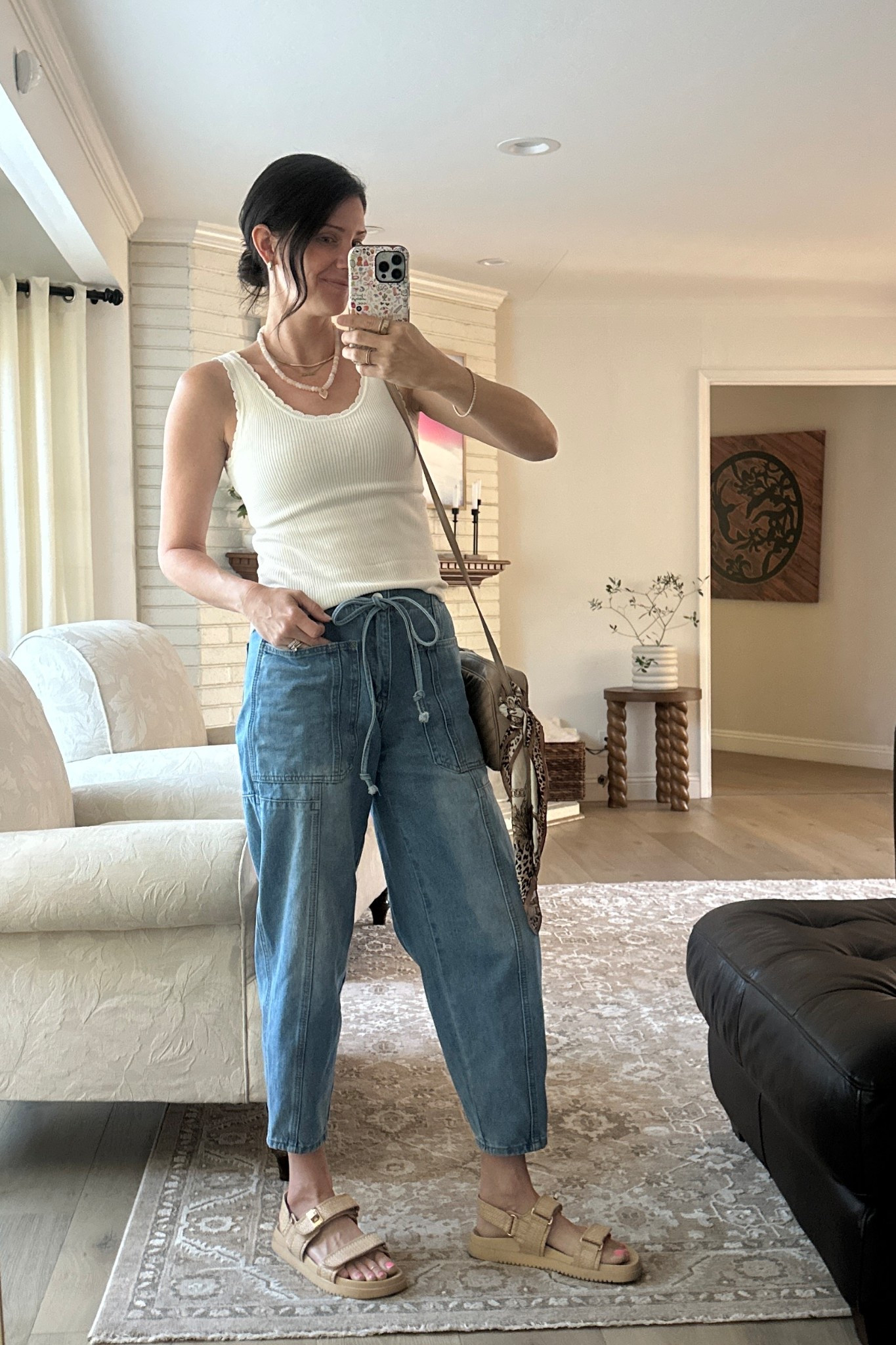 I love the ribbed details and scalloped edges of this tank. Would be so cute under a cardigan once the temps drop. These barrel jeans have elastic waist in the back and have been a fave for a year now, under $40! Midrise and true to size  

#LTKSaleAlert #LTKFindsUnder50 #LTKStyleTip