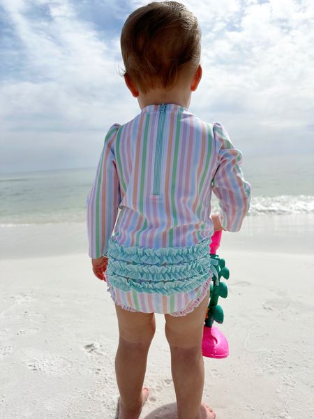 Love this sweet swimsuit for toddlers! Snaps, long sleeves, and the cutest ruffles! 

#LTKfindsunder100 #LTKfindsunder50 #LTKfamily