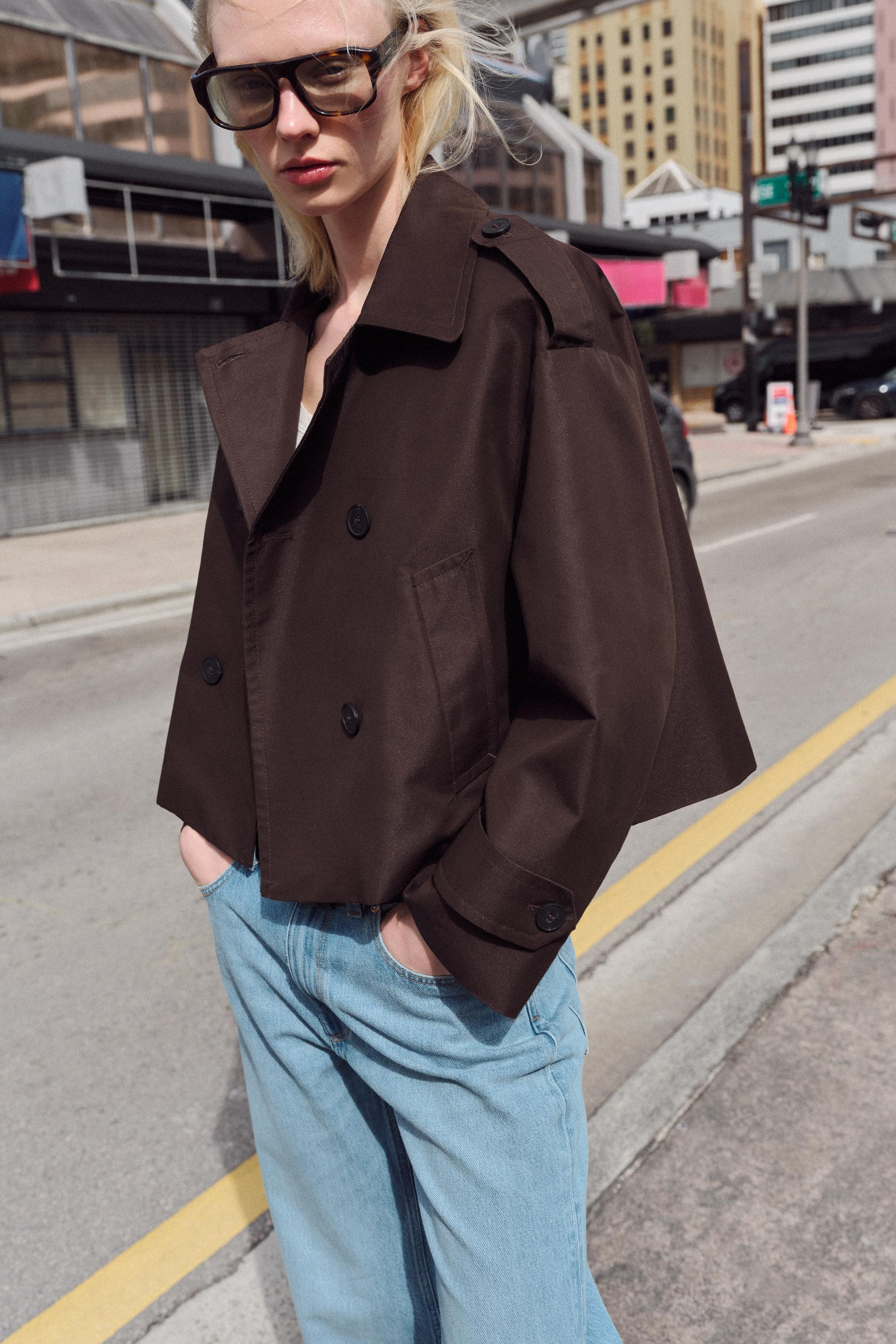 Trench coat with a lapel collar and long sleeves with tabs. Featuring front welt pockets and a do... | Zara UK