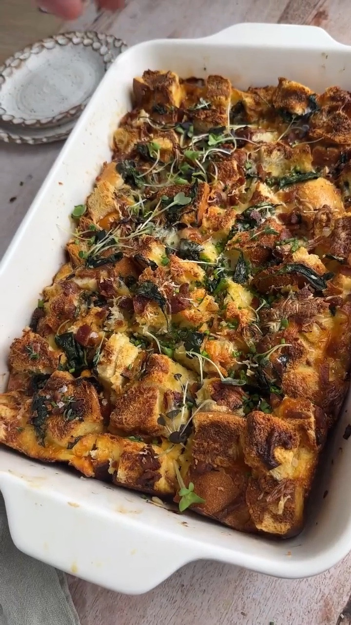 This savory Breakfast Strata is a comforting casserole made with layers of bread, eggs, spinach, bacon, and cheese. The bread soaks up the egg mixture, resulting in a rich, custard-like texture. Baked to golden perfection, it offers a combination of crispy edges, melted cheese, and tender, flavorful bites. Make the day before and bake in the morning, perfect for breakfast or brunch gatherings.

#LTKHome