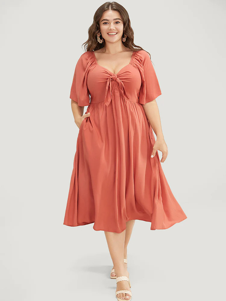 Solid V Neck Ruched Knotted Pocket Ruffle Hem Dress | Bloomchic