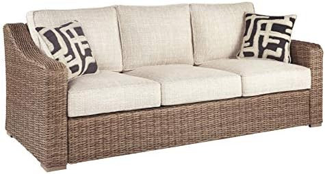 Signature Design by Ashley Beachcroft Outdoor Wicker Patio Sofa with Cushion and 2 Pillows, Beige | Amazon (US)