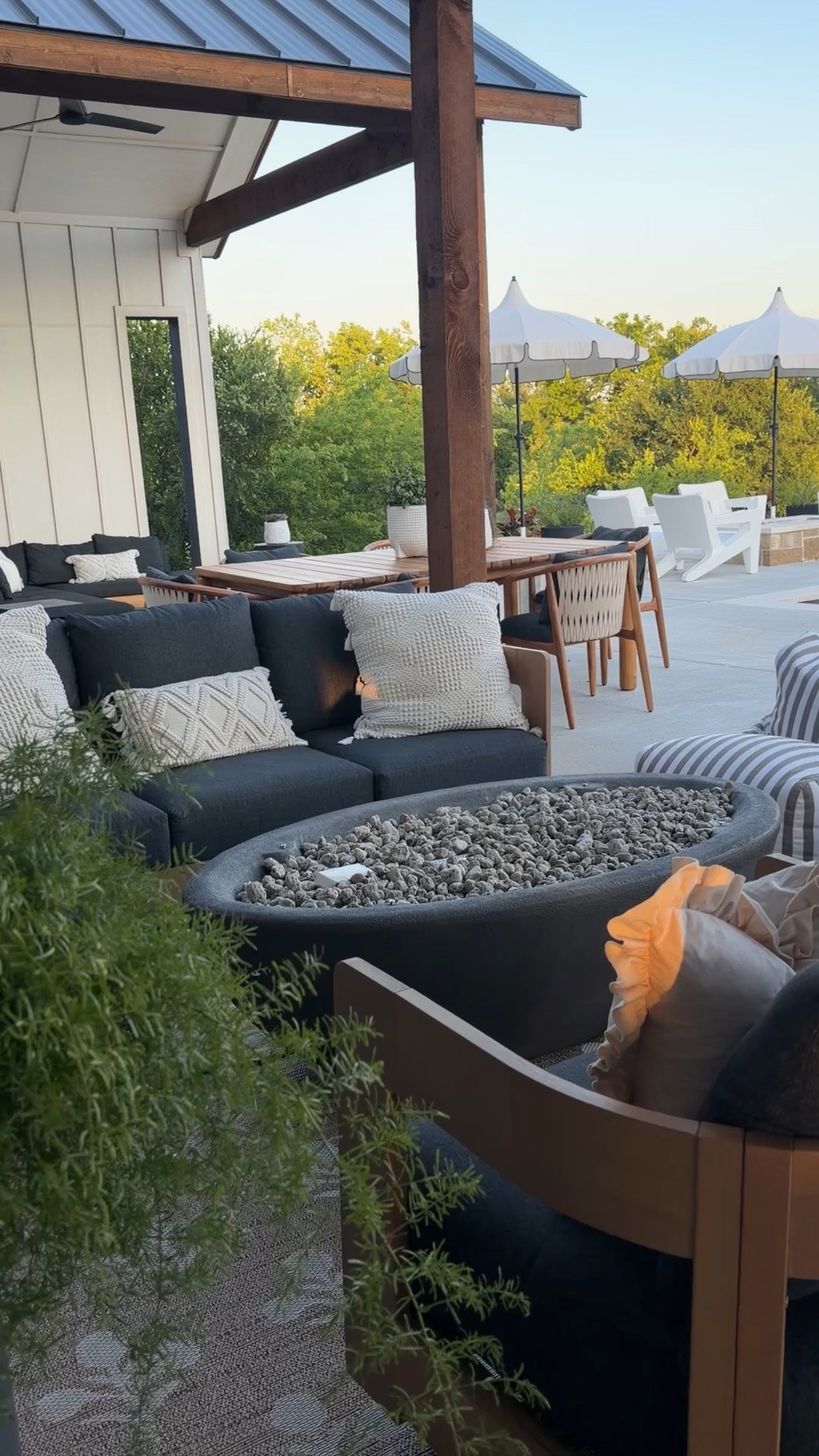 Our patio is officially summer ready ☀️ This outdoor setup has quickly become our favorite place to slow down at the end of the day. We mixed high-end looking pieces with affordable finds to create that cozy, resort-style outdoor living vibe without completely blowing the budget.

The outdoor seating, outdoor rug, and fire pit are all from Wayfair and I love how warm and modern the wood tones feel against the black cushions. The striped bean bag loungers are still one of our most asked about patio finds, and the scalloped umbrellas from Walmart look SO designer for such a good price point. We finished the space with our teak outdoor dining set from Denver Modern for the perfect mix of modern organic and relaxed outdoor entertaining.

Keywords: outdoor patio ideas, backyard patio inspiration, outdoor furniture, Wayfair patio furniture, outdoor swivel chairs, outdoor rug, fire pit patio, backyard makeover, pool patio ideas, resort style backyard, modern outdoor furniture, Walmart patio umbrella, scalloped patio umbrella, striped bean bag chairs, outdoor entertaining space, neutral outdoor decor, modern organic patio, outdoor living space, backyard design, patio decorating ideas, Denver Modern dining set, teak outdoor dining table, luxury backyard ideas

#LTKHome #LTKSaleAlert #LTKSeasonal