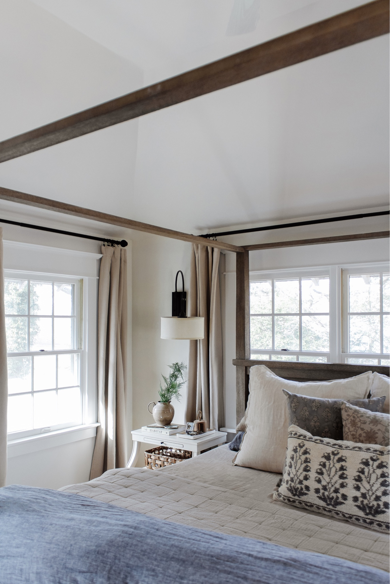 Back in our bedroom and we’ve never been happier ✨ Reno updates to come, but today I’m talking these curtains and a few other items I’m loving at the moment! Head to stories and/or the link in bio to learn more and shop.
•
•
•

4 poster wood bed, natural tone wood bed, canopy bed, linen duvet, stripe euro shams, floral decorative pillow, bed pillows, pillow inserts, cotton gauze quilts, layered bedding, nightstand decor, white two shelf nightstand, affordable furniture, quick ship furniture, swing light, nightstand wall light, affordable curtain, neutral bedroom, bedroom decor, black curtain rod, vintage decor, Target home, woven basket, lumbar pillow, floral throw pillow cover, blue bedding  

#LTKunder50 #LTKhome #LTKstyletip