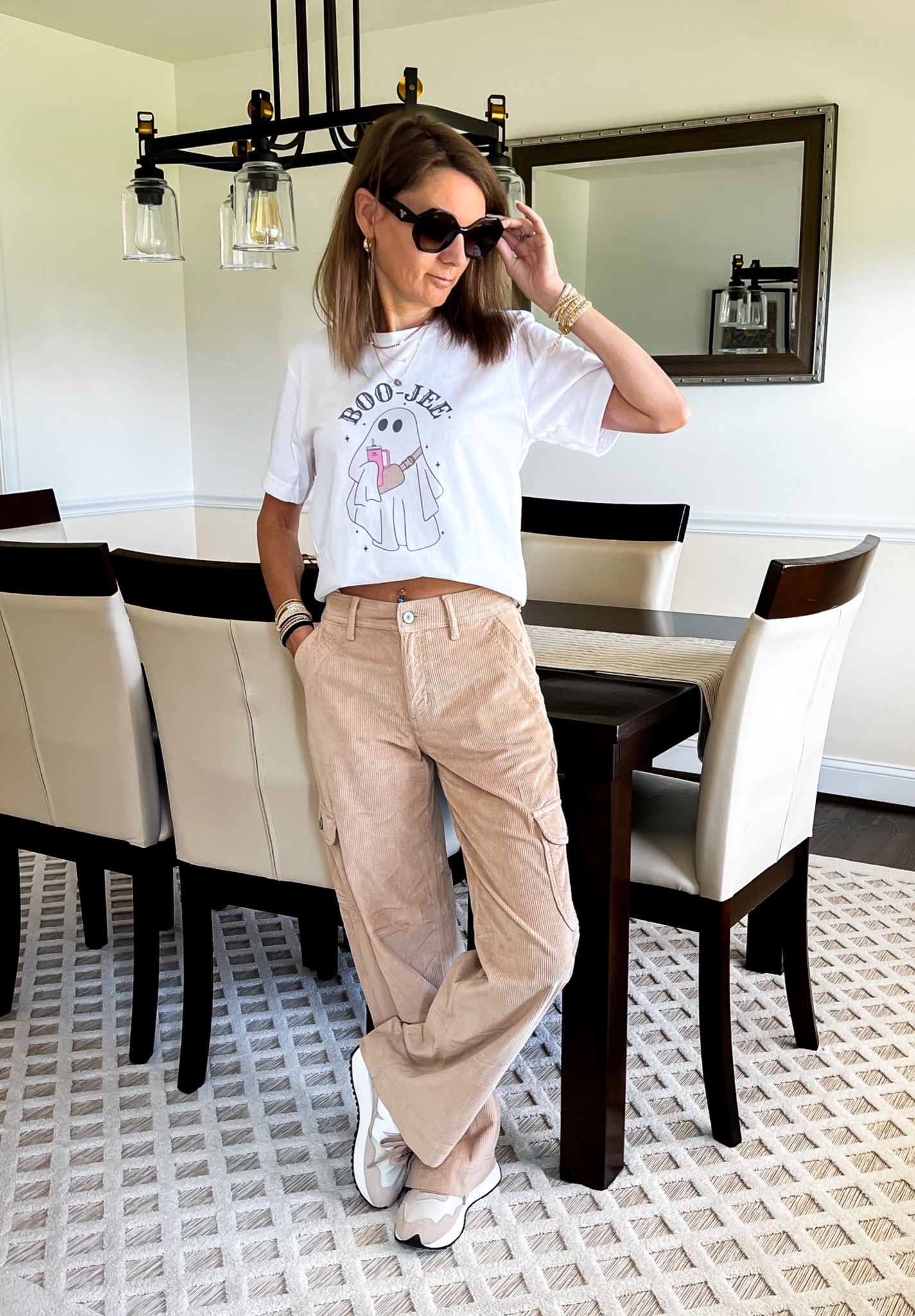 Sweet Sparkle by GG white Boo-jee ghost t-shirt. The ghost is wearing a Lululemon everywhere belt bag and carrying a pink Stanley travel mug! American Eagle high waisted corduroy baggy cargo pants, currently 30% off. Victoria Emerson wrap bracelets. 

#LTKSeasonal #LTKsalealert #LTKHalloween