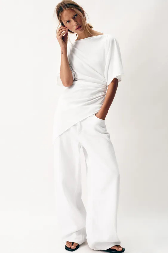 Boat neck top with short sleeves. Featuring draped detailing on the side and an asymmetric hem. | Zara UK