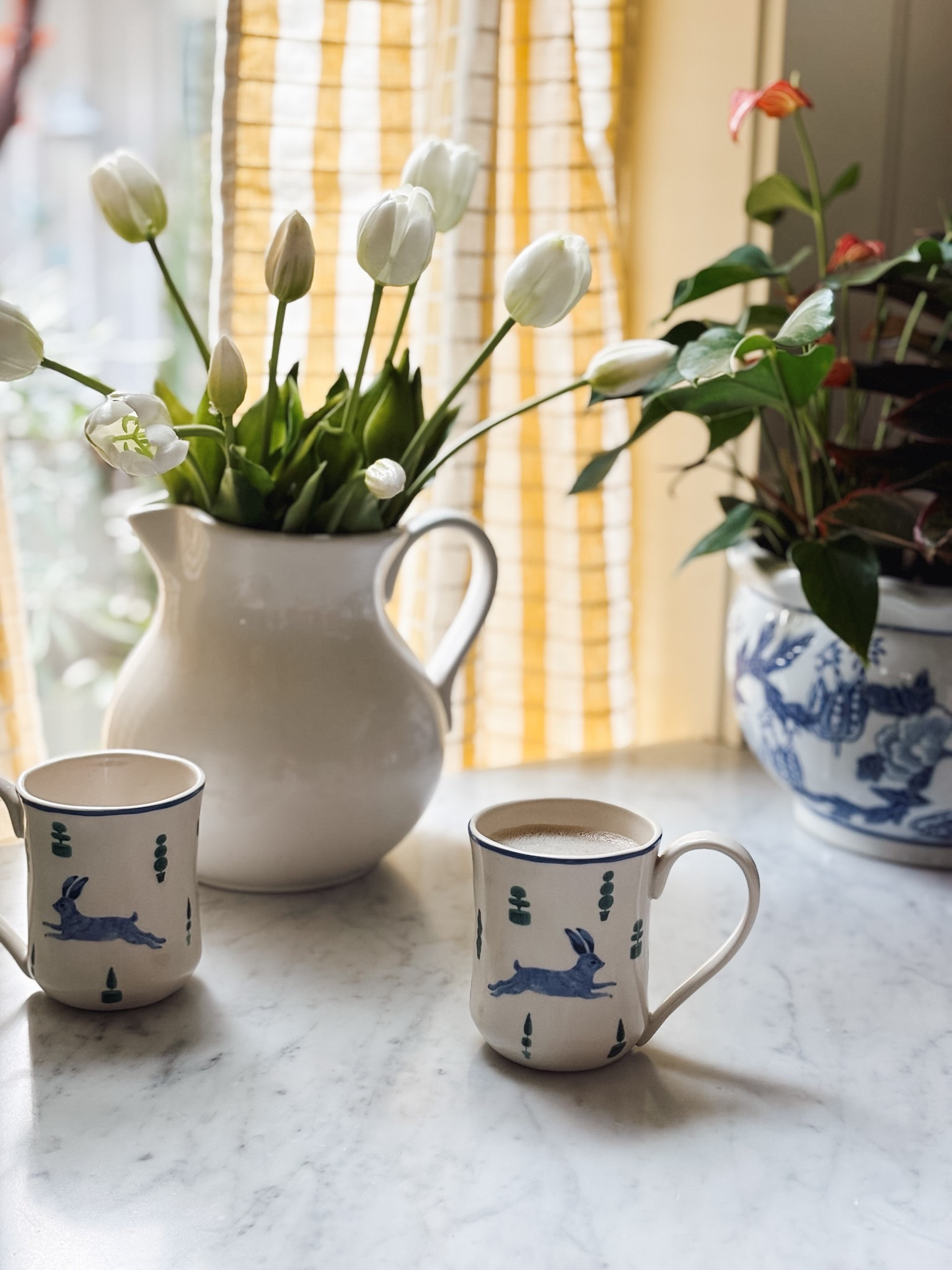Bunny stoneware mugs, yellow check cafe curtains, faux tulips, blue and white planter pot

#LTKSaleAlert #LTKHome #LTKStyleTip