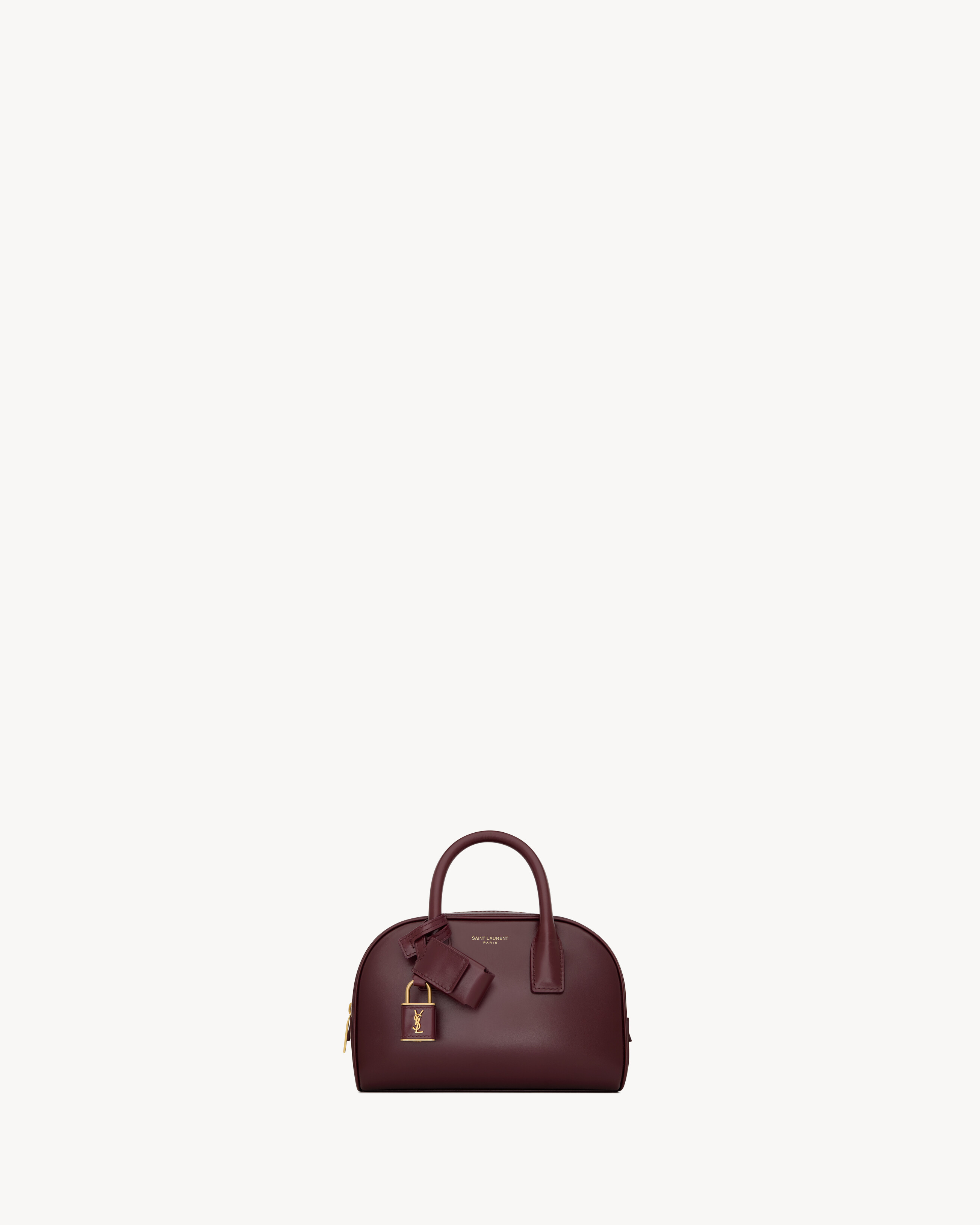 The mini boston bag version of the iconic SAC DE JOUR. This elegant, supple bag features top hand... | Saint Laurent Inc. (Global)