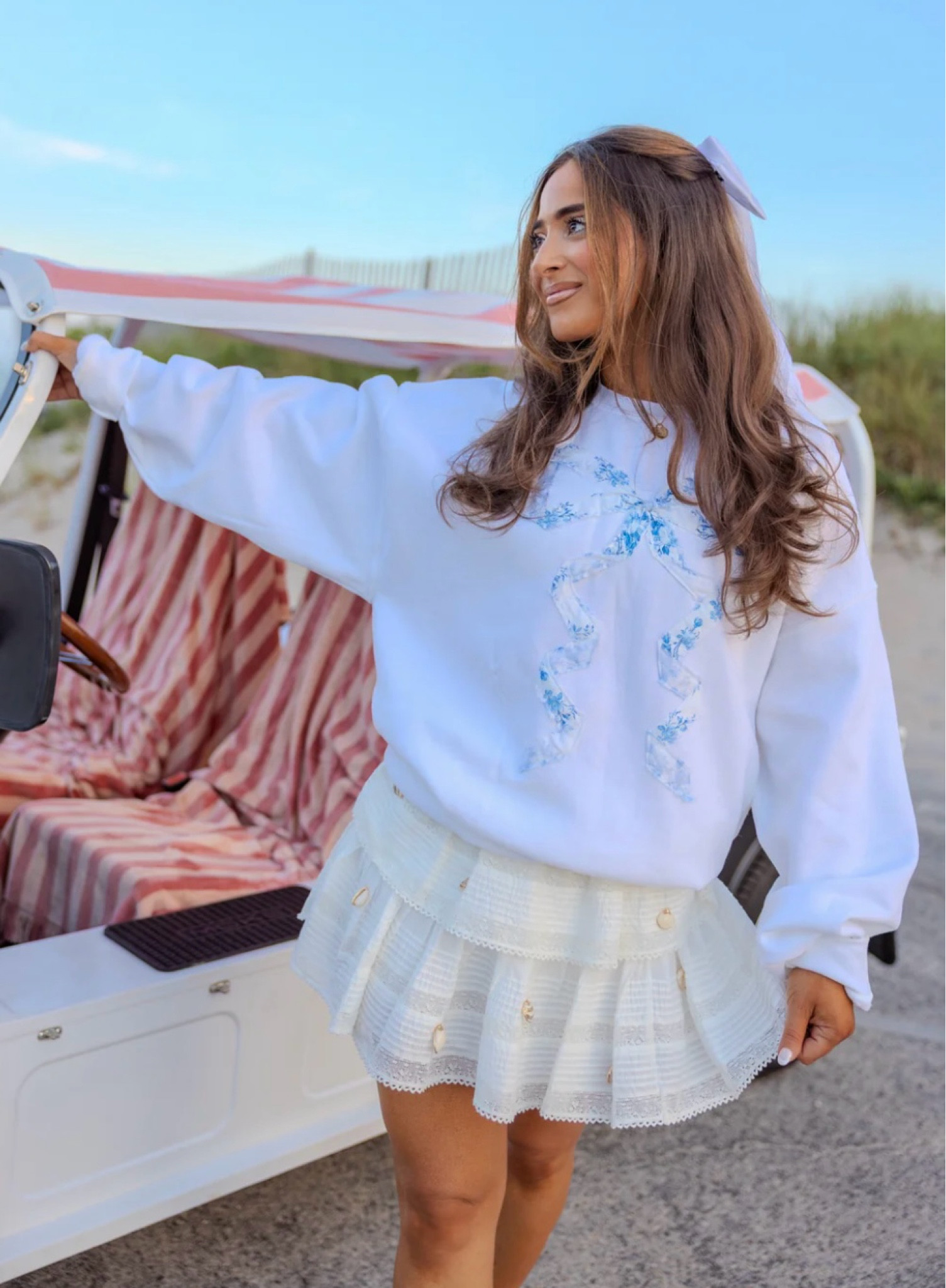 Cozy meets couture 🤍 This oversized white sweatshirt, topped with a sweet blue and white bow, is the perfect blend of comfort and charm—because every outfit deserves a little statement these summer nights 

#LTKBeauty #LTKSeasonal #LTKStyleTip