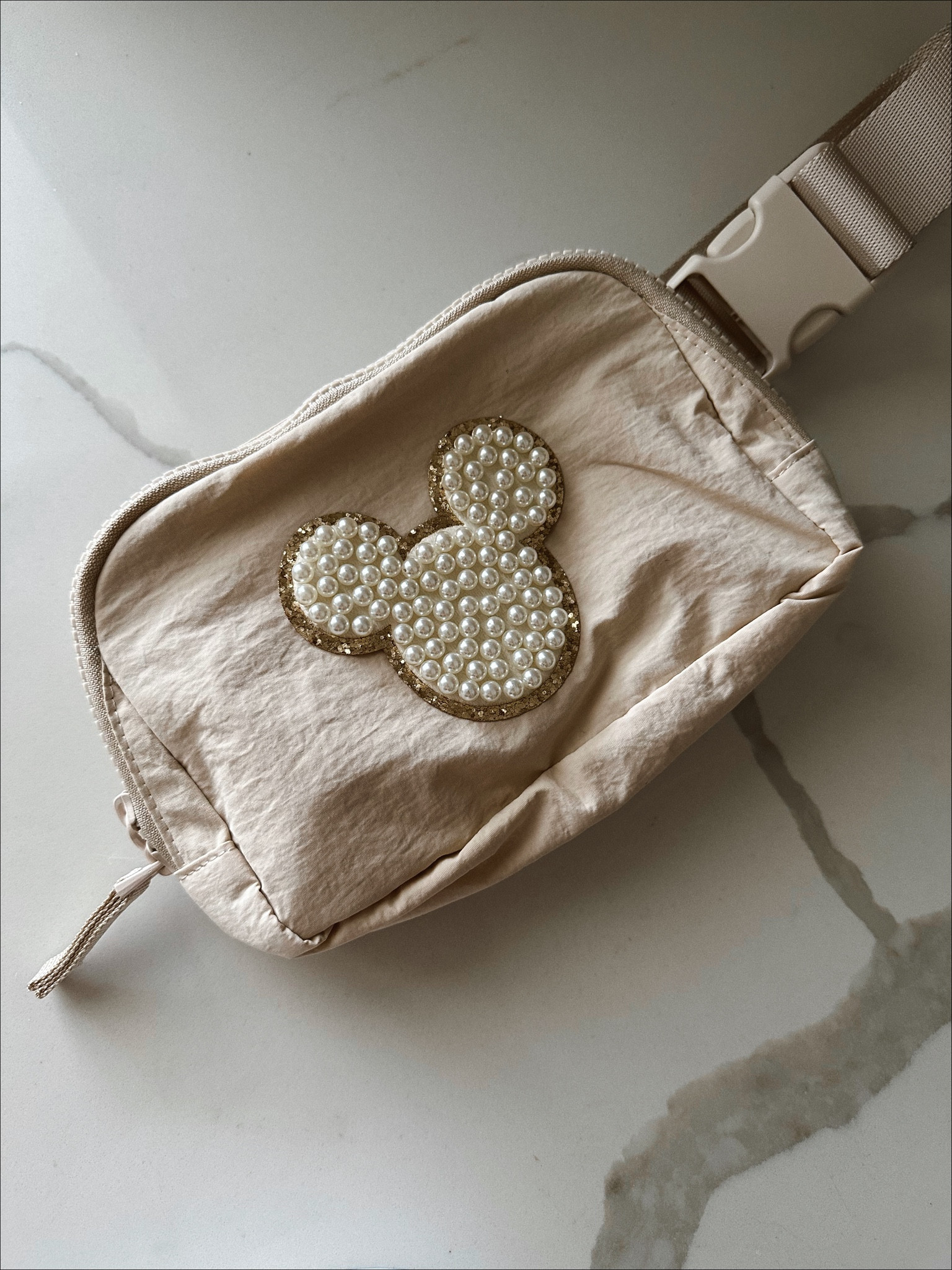 Disney belt bag DIY 🤍 #disney #disneyworld #disneyland #stoneyclover #DIY #disneypatch #fannybag #disneybag #disneybeltbag #disneypearlpatch #mickey #minnie #beltbag #neutraldisney #amazon #amazonfinds 

#LTKunder50 #LTKFind #LTKtravel