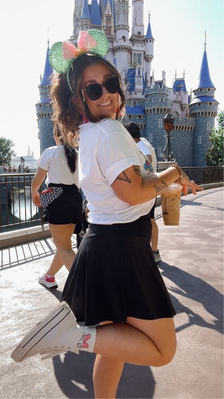 Cute dis eh world vacation amusement park outfit! Wearing medium in Mickey and friends graphic tee. Medium in black tennis skirt with built in shorts. Platform high top converse run TTS. Belt bag with Disney pins and pink tassel earrings and cute Mickey Mouse Minnie Mouse ears! 

#LTKTravel #LTKStyleTip #LTKU