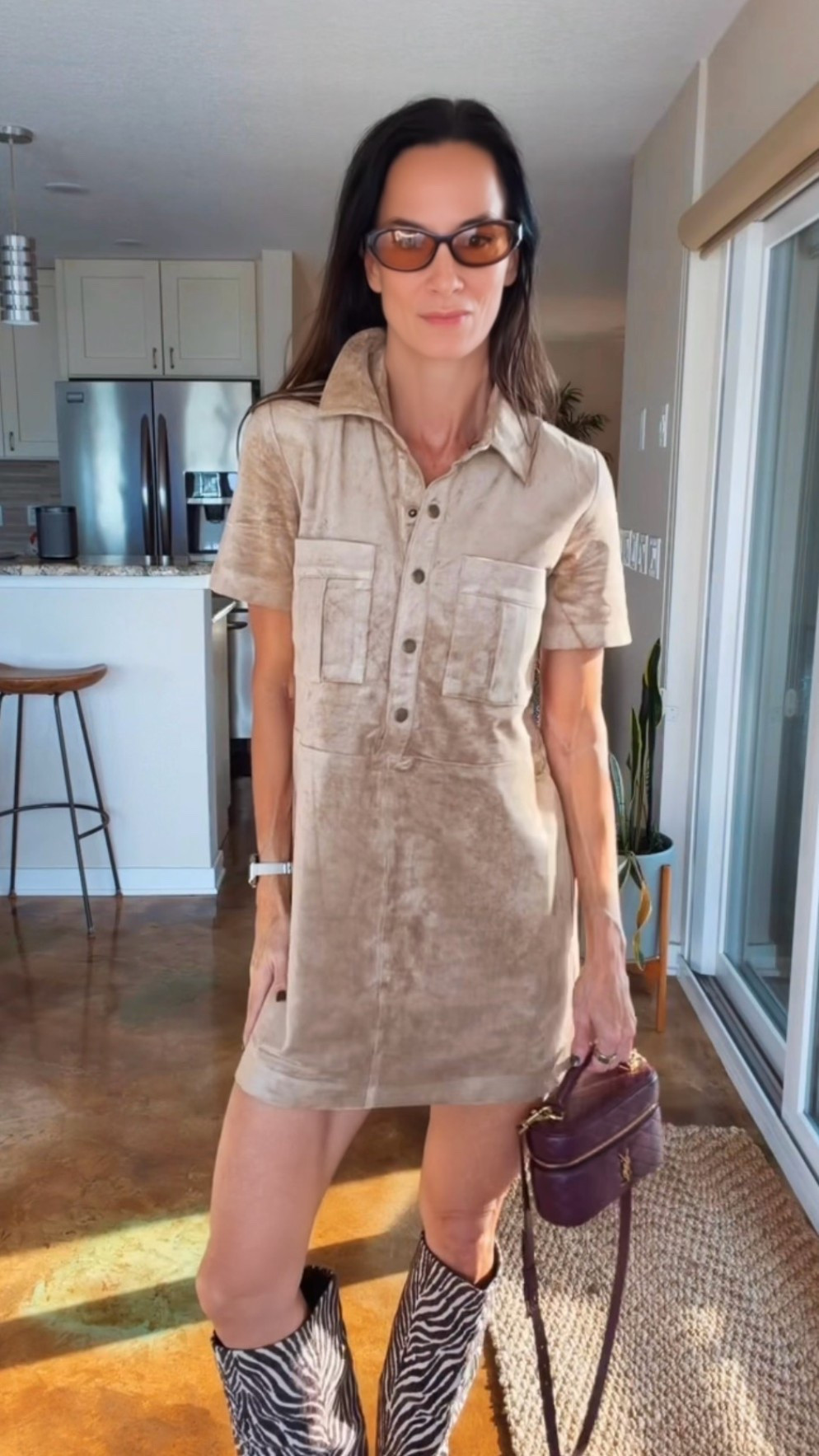 The boots are doing the talking. 🦓🤎 Styled this neutral short-sleeve shirt dress with zebra-print knee-high boots, a burgundy Saint Laurent bag, and brown sunglasses. An easy fall outfit formula: a simple dress + statement boots + a rich-colored bag. Shop the pieces below!