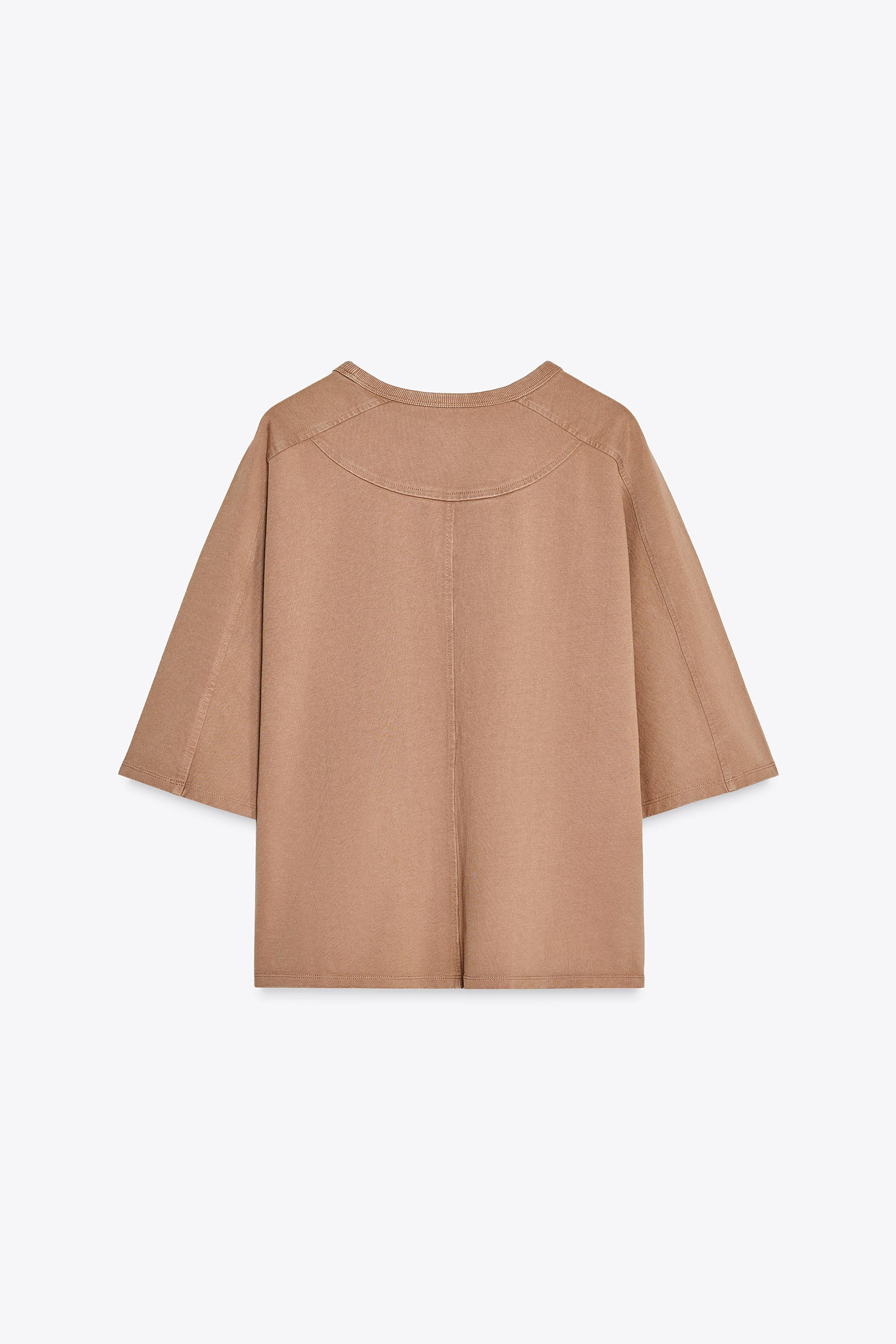 T-shirt made of 100% washed compact cotton. Ribbed round neck. Elbow-length sleeves with dropped ... | Zara US