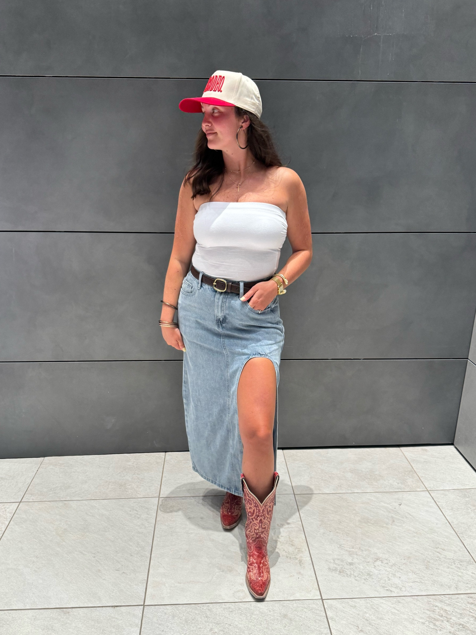 Denim skirts are in 💙 

Trucker hats, concert season, country concert, boots and skirts, tube top, strapless top, maxi denim