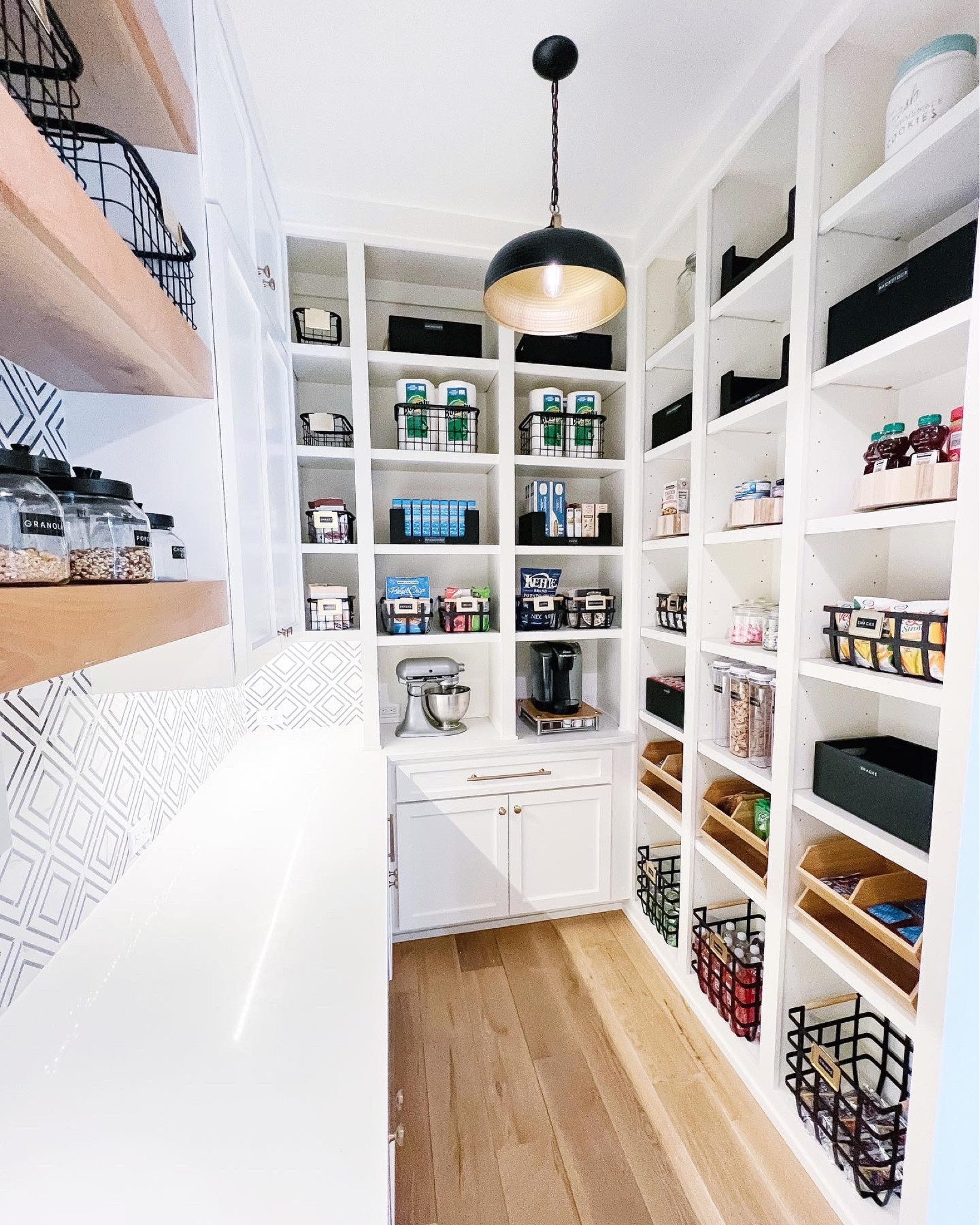 🖤 I’ve fallen in love with a lot of pantries…this one is definitely in the top 5. Isn’t she gorgeous? We used a mix of materials, but took a lot of inspiration from the “Dark & Moody” board you might be familiar with.

💬 Let’s chat products!

• A mix of black wooden & metal baskets provide open storage while adding extra polish to the pantry. I love how they pop against the white shelves, while still tying in the pendants & backsplash.

• The bamboo stackable containers are amazing for little hands to quickly grab a snack. They’re easy to load and look great with the open shelving on the opposite wall.

• Finally, those gold labels. They are just so pretty and add a little glamour to the space. Bonus? They tie in beautifully to the gold hardware throughout their home.

🖤 An organized, functional system is ALWAYS my goal. However, creating spaces that reflect both the style and personality of the home and the client is so important.

#LTKunder50 #LTKhome #LTKfamily