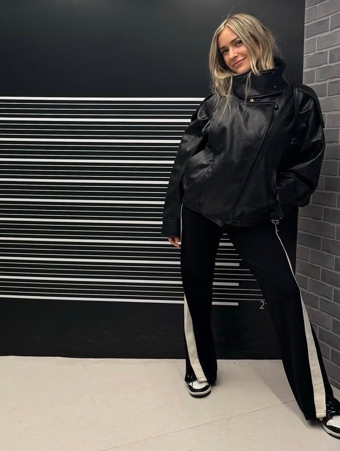 Shop Kristin Cavallari black funnel neck leather jacket white track pants with side zip ￼