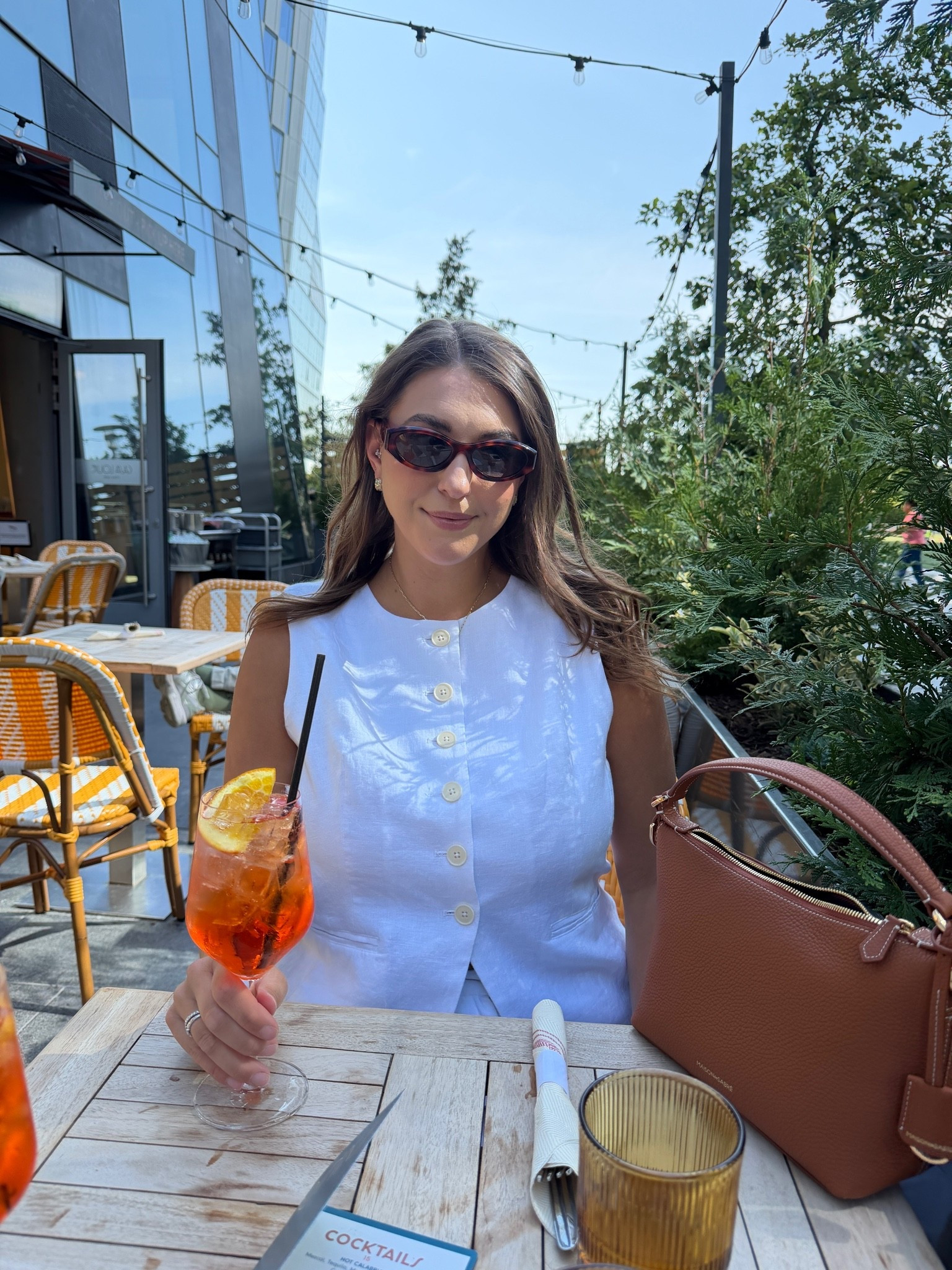 The chicest warm-weather lunch look 🤍 A crisp white linen vest, tortoise sunglasses, and a rich cognac bag make this simple outfit feel instantly polished and expensive.

white linen vest, summer outfit, lunch outfit, cognac handbag, tortoise sunglasses, elevated basics, neutral style, chic summer outfit, classic style, effortless fashion

#LTKdayinmylife #LTKSeasonal #LTKTravel