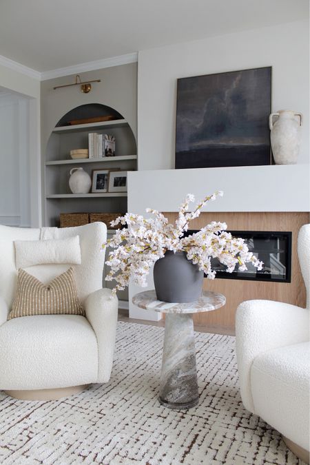 Modern organic neutral decor with touch of moody, accent chairs, marble accent table, end table, vase, spring flowers, throw pillows, wall canvas, wall art, target home decor, Walmart home furniture, rug, Amazon fireplace insert 

#LTKhome #LTKstyletip #LTKSeasonal