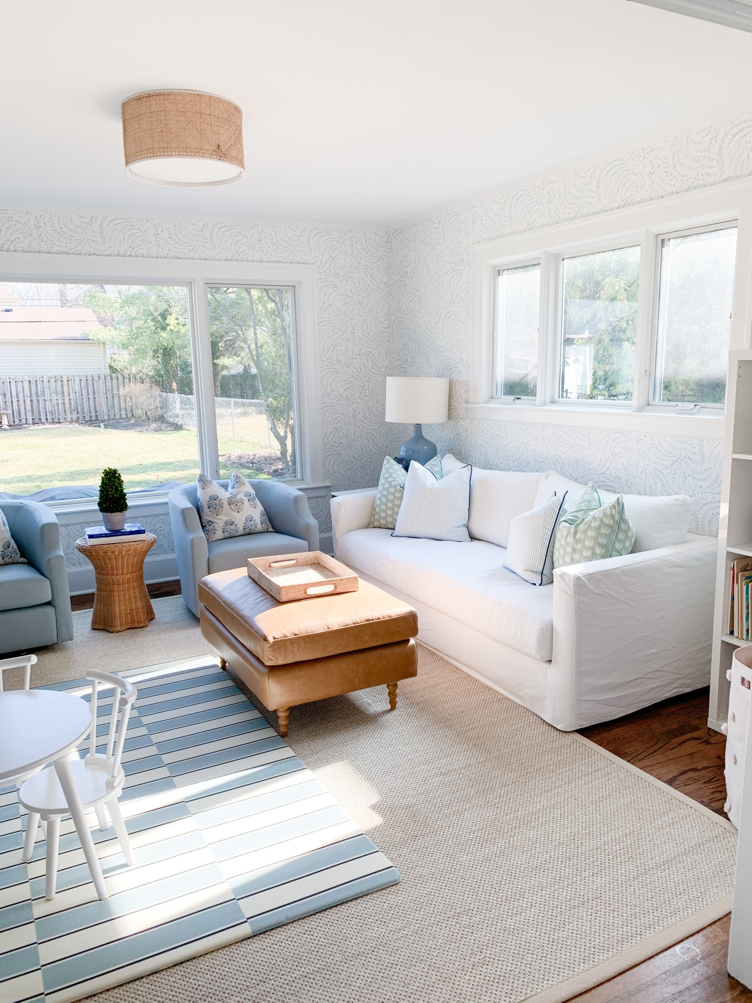 Blue swivel chairs, white couch, coastal living room, rattan flush mount light 

#LTKhome #LTKfindsunder100