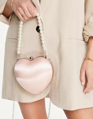 True Decadence Exclusive heart clutch bag in pink satin with pearl handle | ASOS (Global)