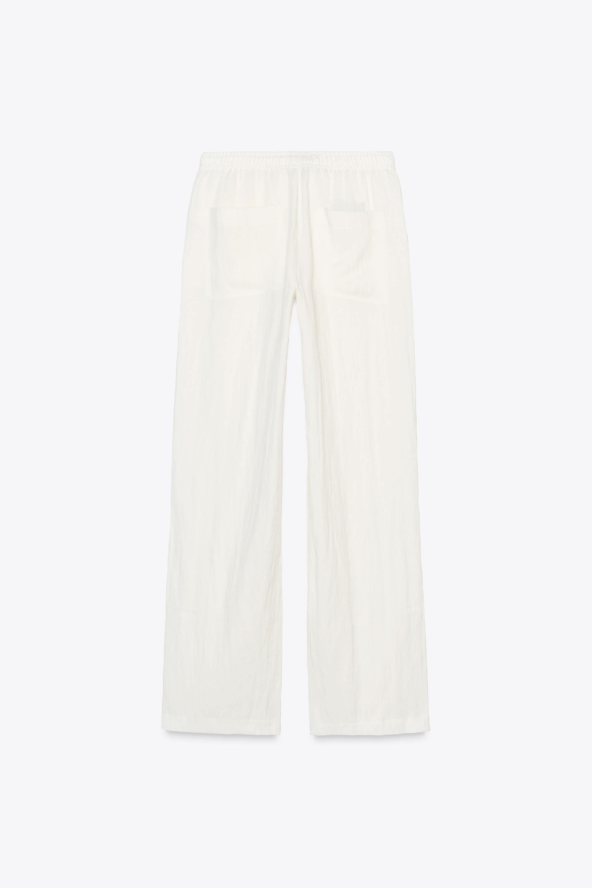 Mid-waist trousers with an adjustable elasticated waistband with drawstrings. Side pockets and pa... | Zara UK