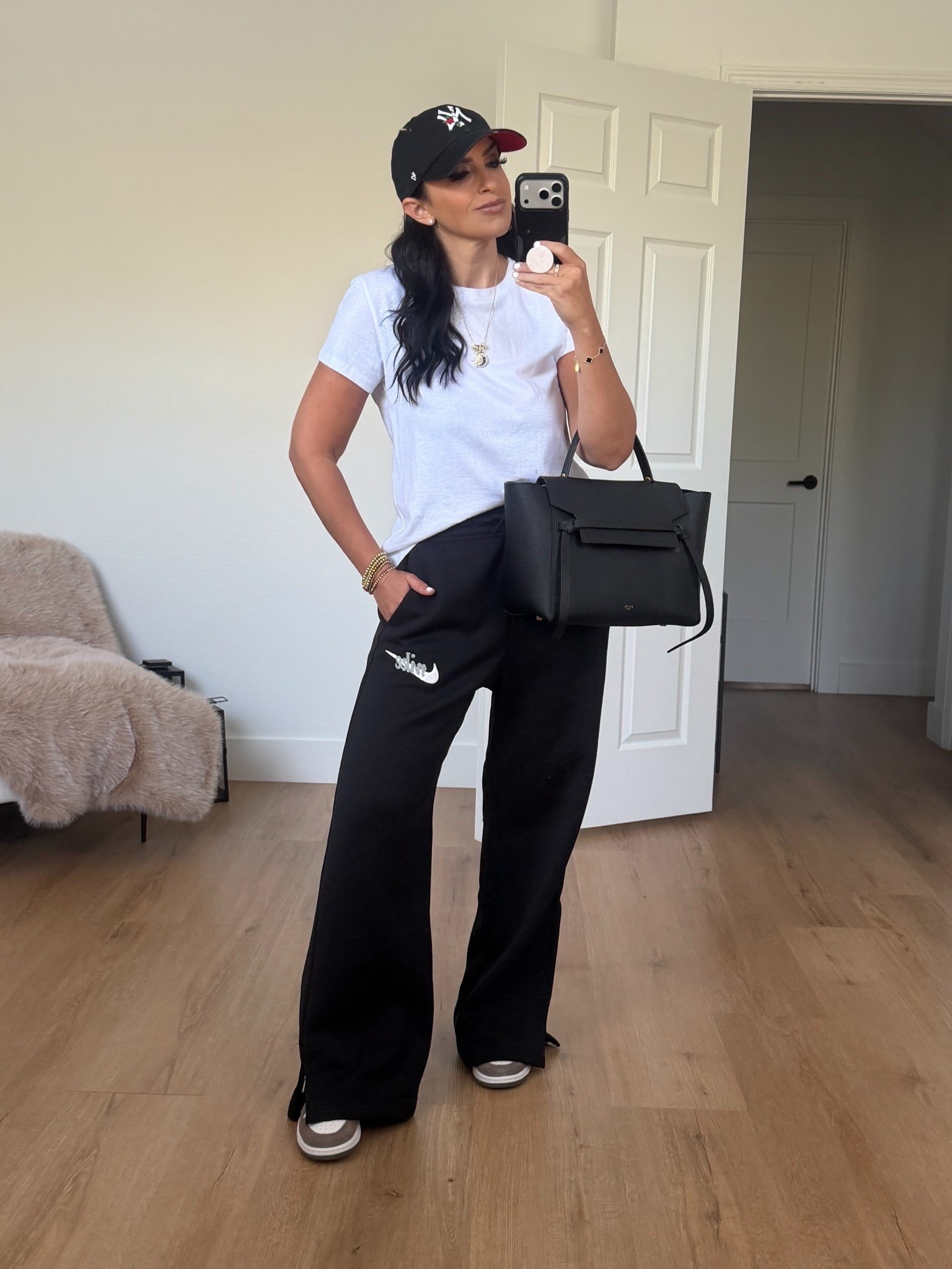 Nike sportswear phoenix fleece women’s high waisted wide leg logo pants black summit white wearing size medium 