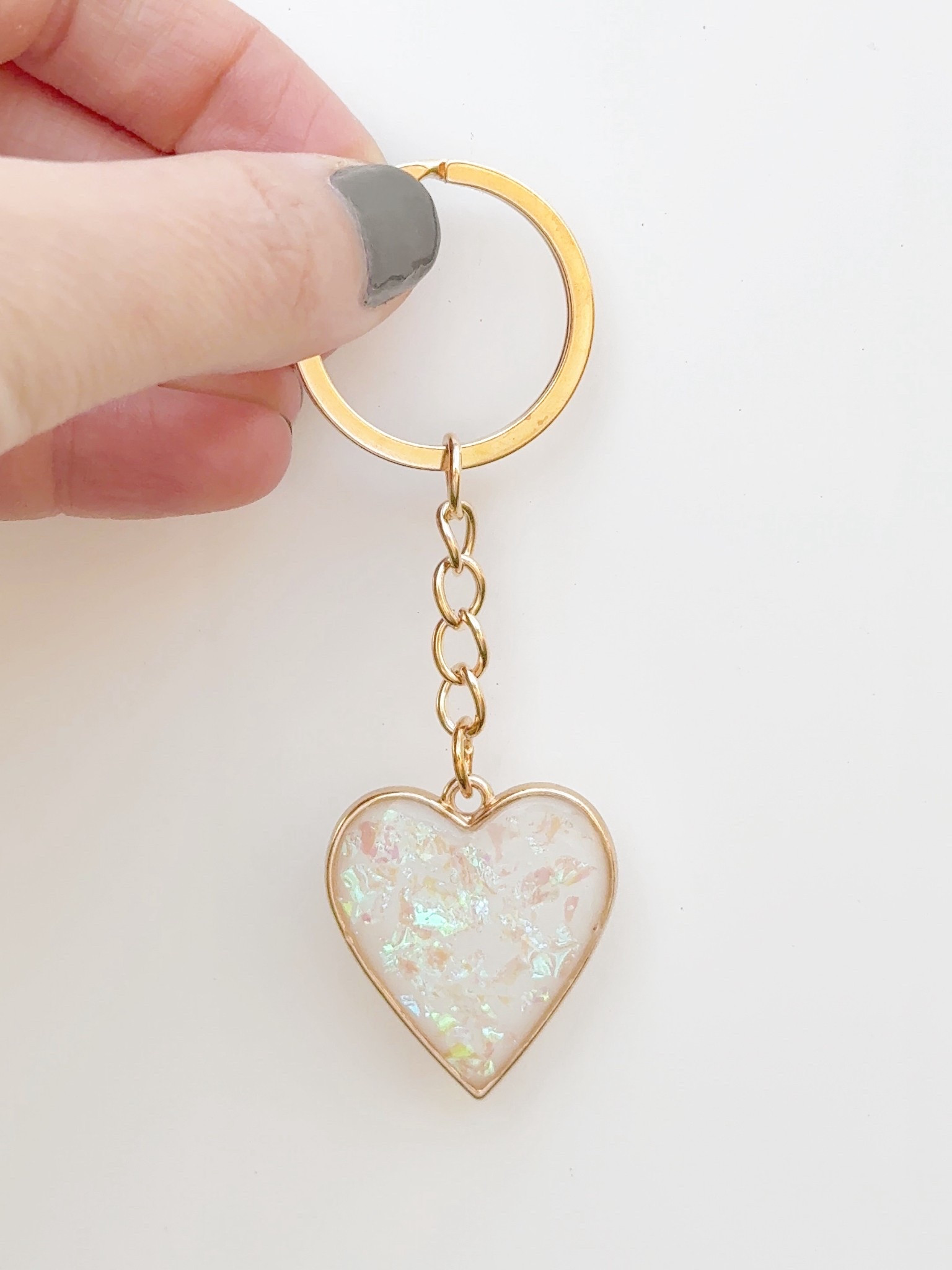 DIY white heart keychain made with resin and foil flakes🤍 Fun and easy craft made using this resin kit! 

#LTKValentine