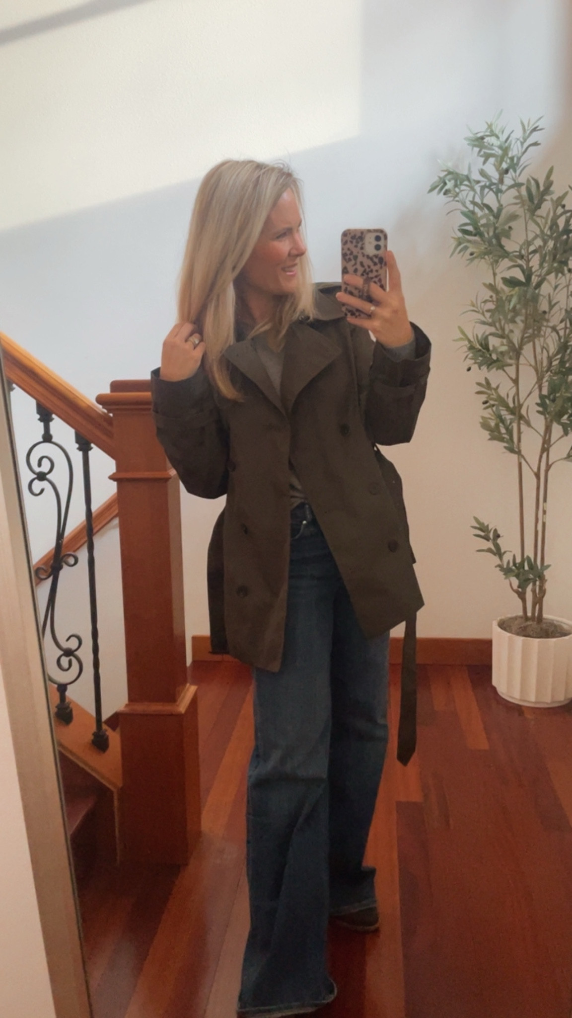 This outfit is the perfect mix of **classic pieces with a fresh pop of color** 💚

The green trench coat instantly makes a statement while still feeling timeless and polished. It’s one of those outerwear pieces that elevates even the simplest outfit the moment you put it on. Layered over a soft gray cashmere sweater, the look feels cozy, refined, and effortlessly put together — the kind of combination that works for everyday wear but still looks elevated.

The wide-leg jeans add a modern touch while keeping the outfit comfortable and relaxed. I love how the structured shape balances the softness of the sweater and the tailored feel of the trench. It’s a great example of mixing classic staples with updated silhouettes.

Finished with brown suede loafers, the outfit feels warm, neutral, and cohesive. The suede texture adds a subtle richness that ties everything together beautifully. This is the kind of outfit that works for coffee dates, casual meetings, errands, or travel days when you want to feel polished but still comfortable.

Simple, classic, and effortlessly chic — proof that great basics always make the best outfits. 🤍

**Keywords:** trench coat outfit, Aritzia trench coat, J.Crew cashmere sweater, wide leg jeans outfit, casual chic outfit, neutral outfit ideas, classic everyday style, effortless fashion, capsule wardrobe, elevated basics, timeless outfit
