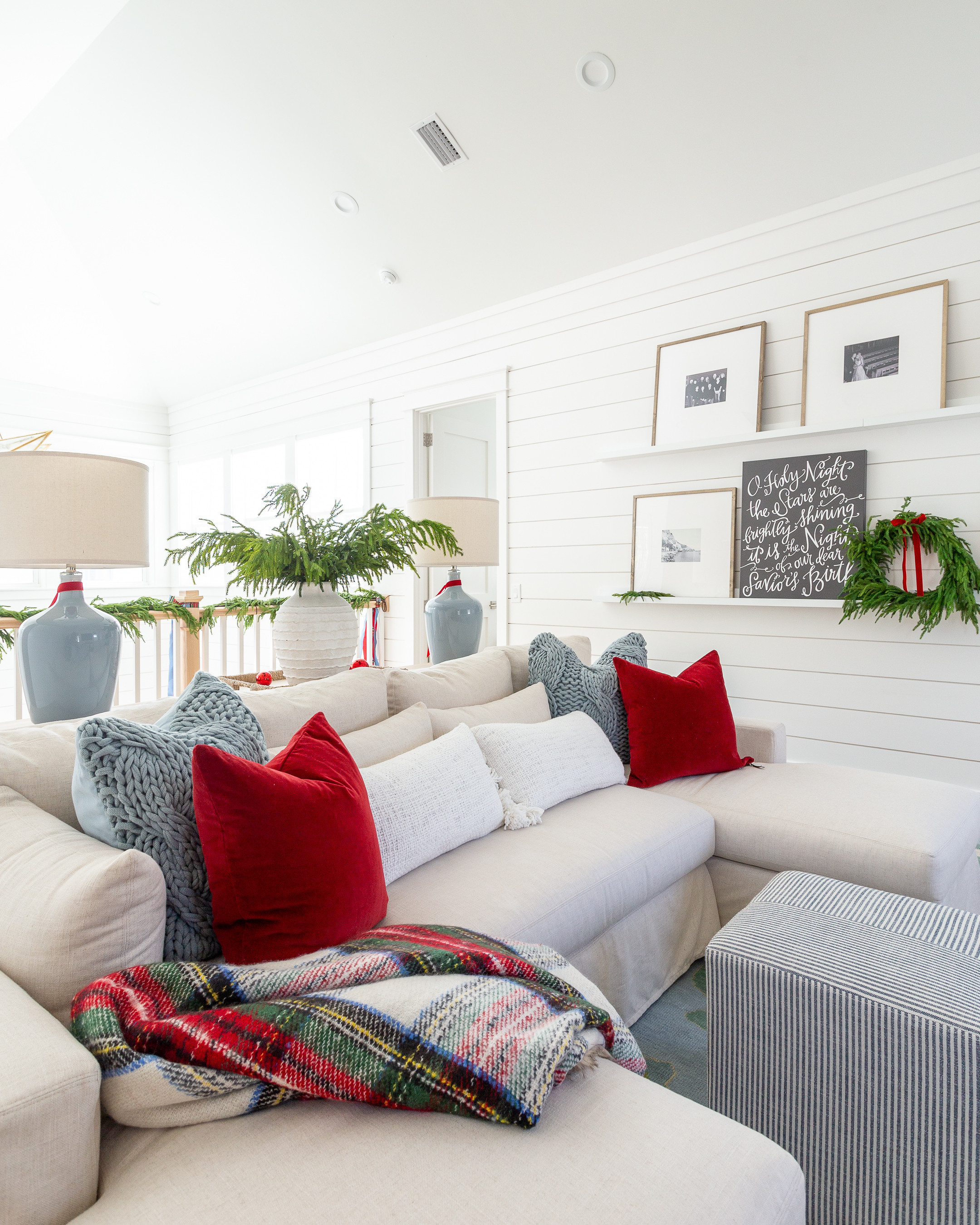 Our coastal loft with white shiplap walls decorated for Christmas with red velvet pillow and light blue knit pillows on our linen sectional, "O Holy Night" art, real-touch Norfolk pine stems in a white terra cotta vase, picture ledge gallery wall frames, and light blue ceramic lamps. See our full Christmas home tour here: https://lifeonvirginiastreet.com/2024-christmas-home-tour/ #ltkholiday #ltkhome #ltksalealert #ltkfindsunder50 #ltkfindsunder100 #ltkstyletip #ltkseasonal 

 

#LTKHoliday #LTKHome #LTKSaleAlert